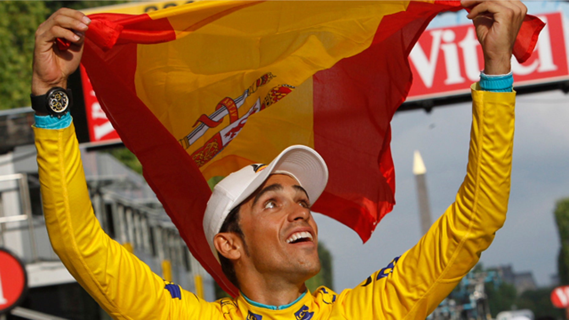 July 25, 2010: FILE - In this file photo, three-time Tour de France winner Alberto Contador of Spain holds aloft the Spanish national flag during a victory lap after winning the Tour de France cycling race in Paris.