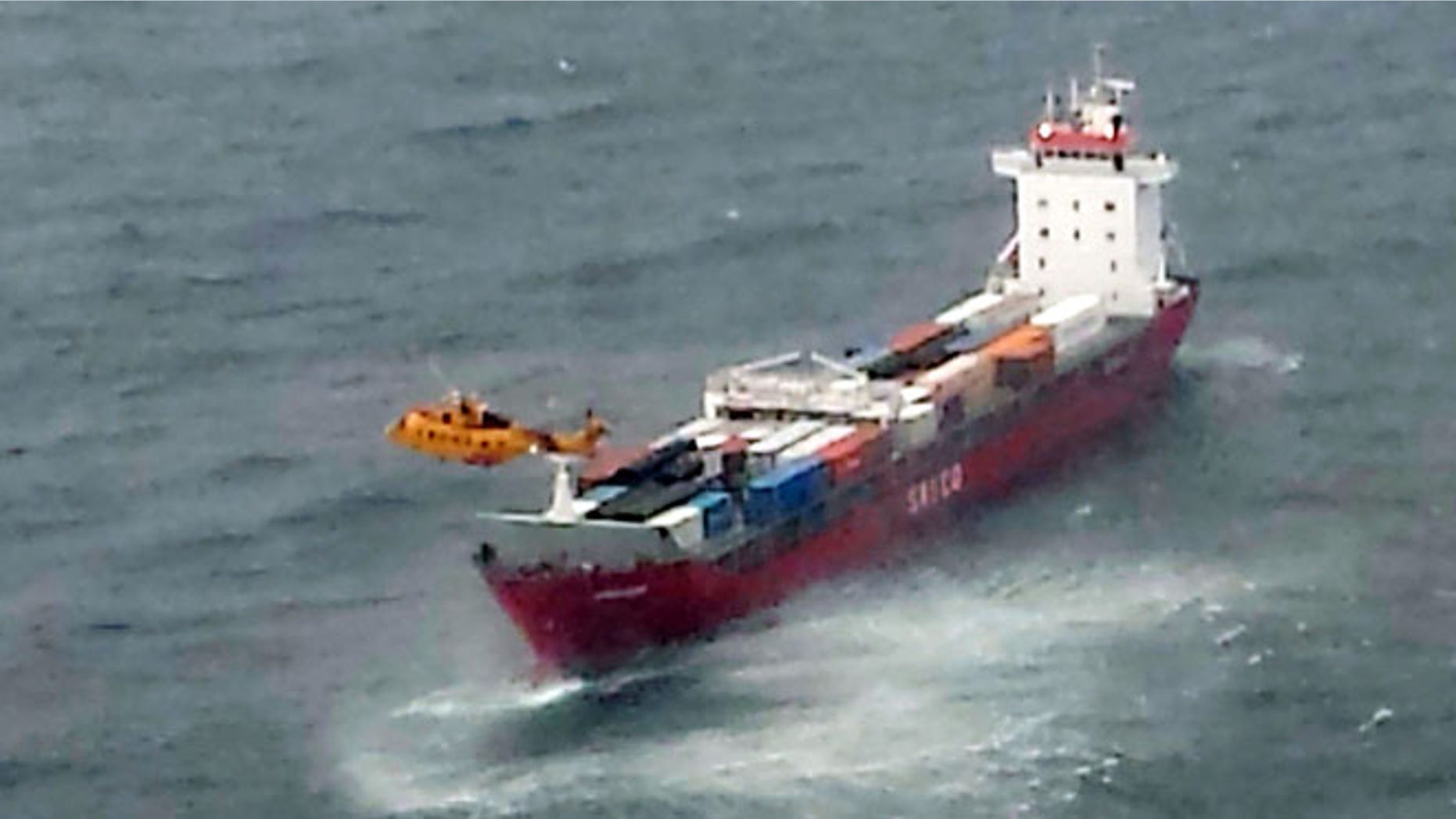 Oct. 17, 2014: A Canadian Coast Guard helicopter flies near a Russian container ship, carrying hundreds of tons of fuel drifting without power in rough seas off British Columbia's northern coast