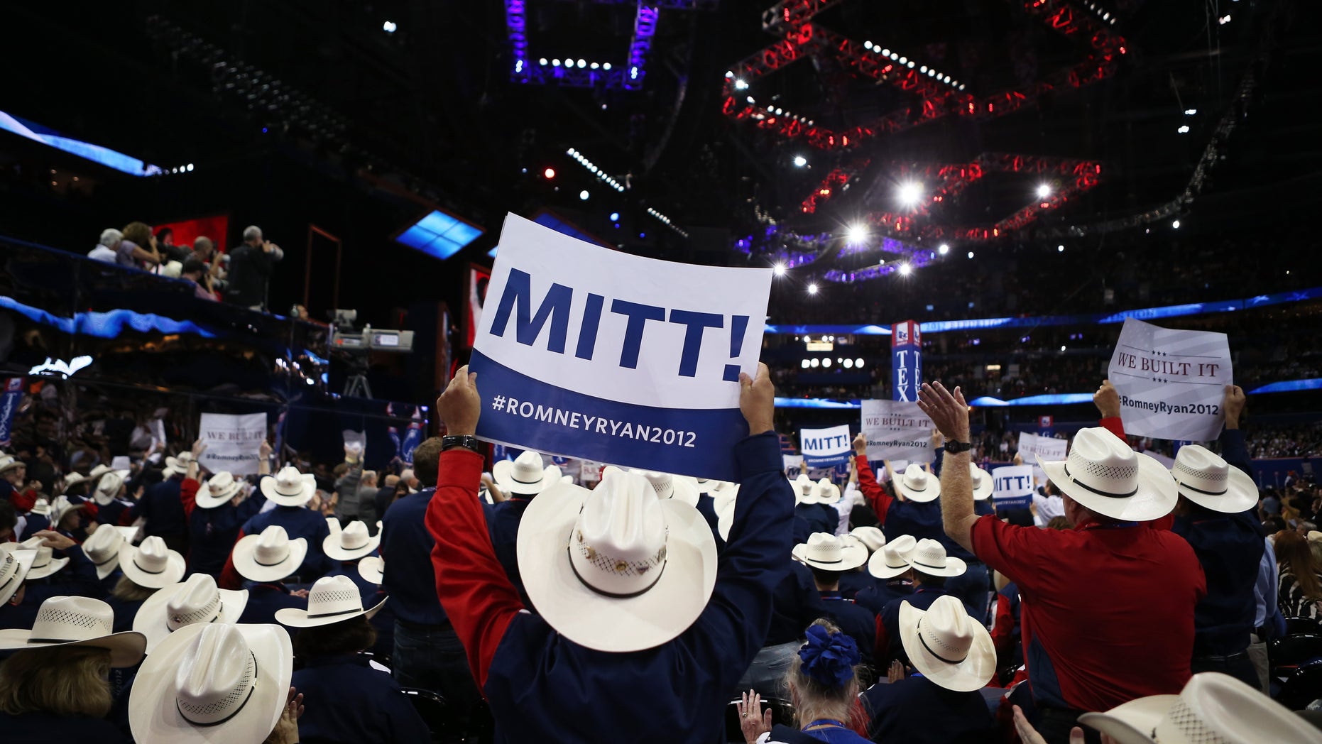 TAMPA, FL - AUGUST 28: People from the Texas delegation hold signs that say "Mitt!" during the Republican National Convention at the Tampa Bay Times Forum on August 28, 2012 in Tampa, Florida. Today is the first full session of the RNC after the start was delayed due to Tropical Storm Isaac. (Photo by Chip Somodevilla/Getty Images)