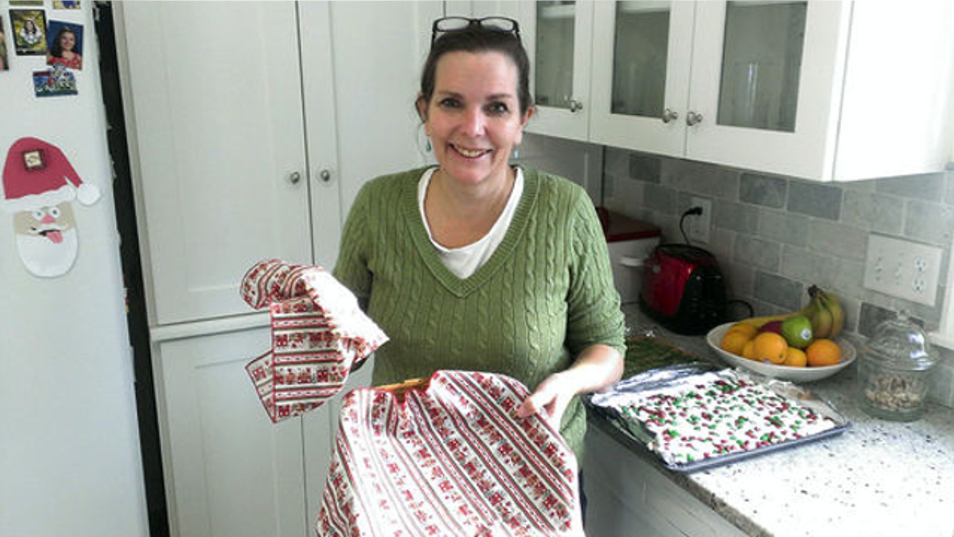 Dec. 20, 2013: Anne Tabat holds the now-empty cookie basket which once was her weapon for getting neighbors to know each other in Chanhassen, Minn. Tabat, a mother who has been baking cookies for the kids on her children's bus for 15 years has been shut down by an anonymous complaint.
