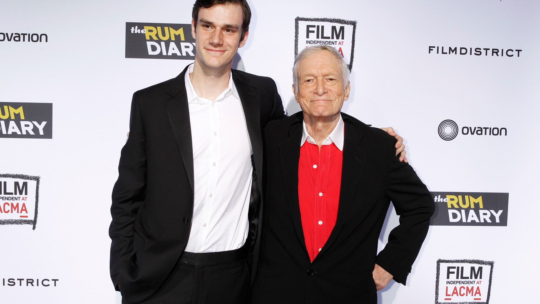 October 13, 2011. Playboy magazine founder Hugh Hefner (R) and son Cooper arrive at the premiere of the film "The Rum Diary" in Los Angeles.