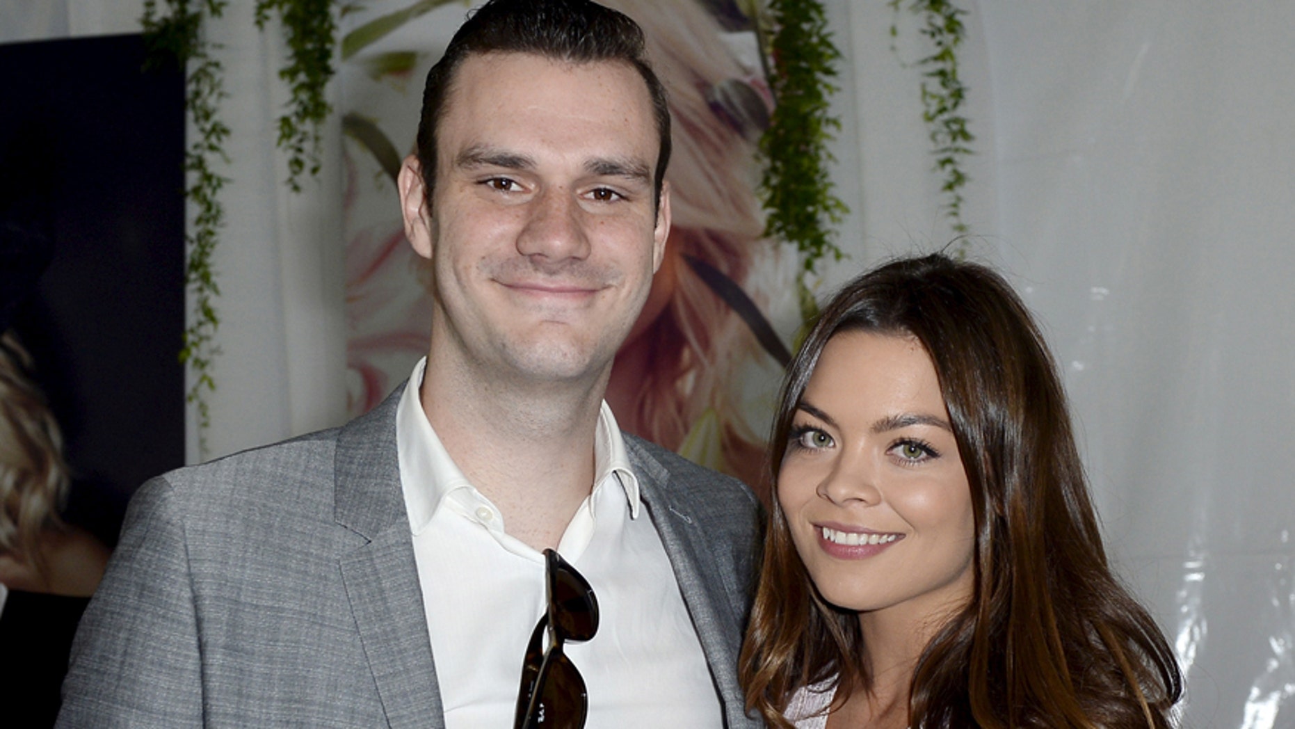 Cooper Hefner (L), son of Playboy founder Hugh Hefner, poses with girlfriend actress Scarlett Byrne, who played Pansy Parkinson in the Harry Potter films, during the announcement of 2015 Playboy Playmate of the Year at a luncheon on the garden grounds of the Playboy Mansion in Los Angeles, California May 14, 2015. REUTERS/Kevork Djansezian - RTX1D12A