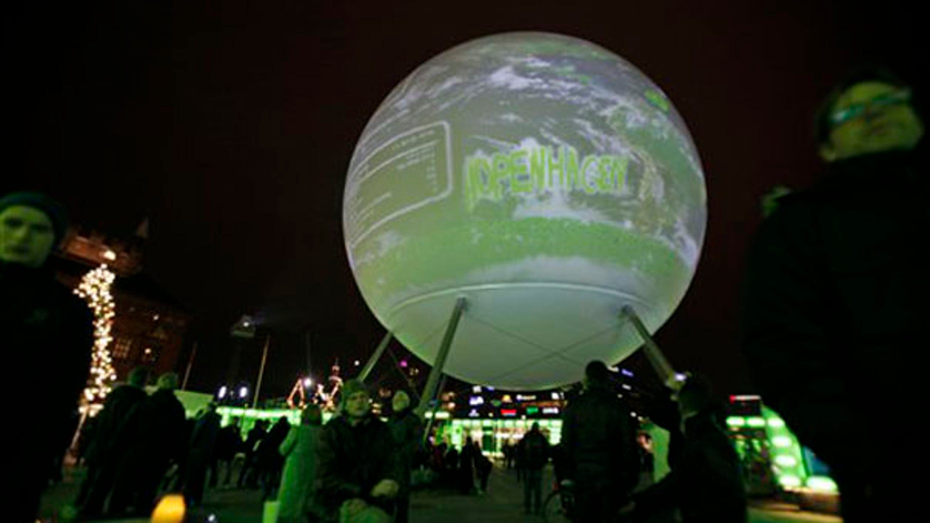 A globe is projected as people are seen in Town Hall Square on the opening day of the Climate Conference in Copenhagen Dec. 7. (AP Photo)