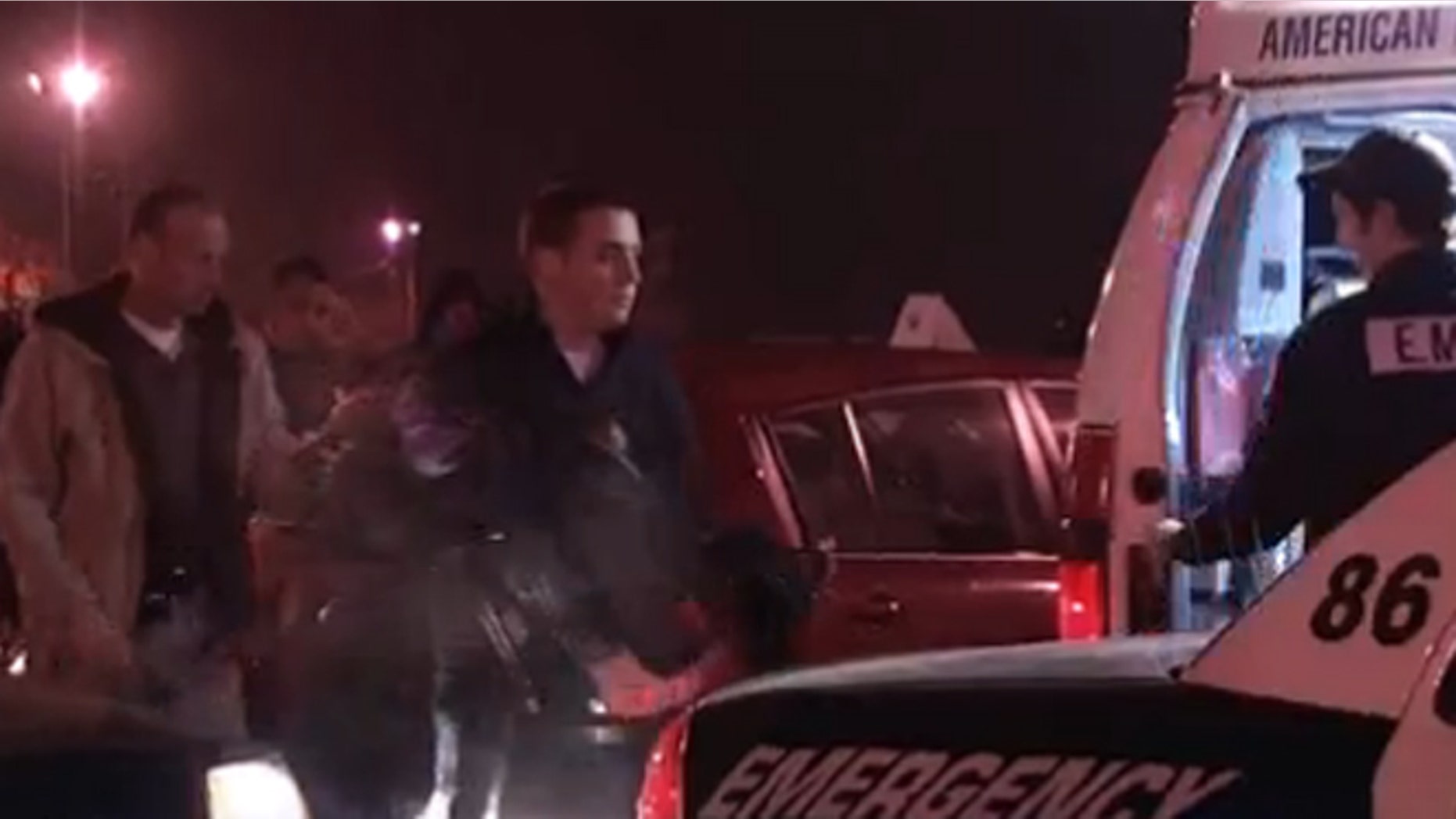 Police remove a 2-year-old child from a car in a K-Mart parking lot.