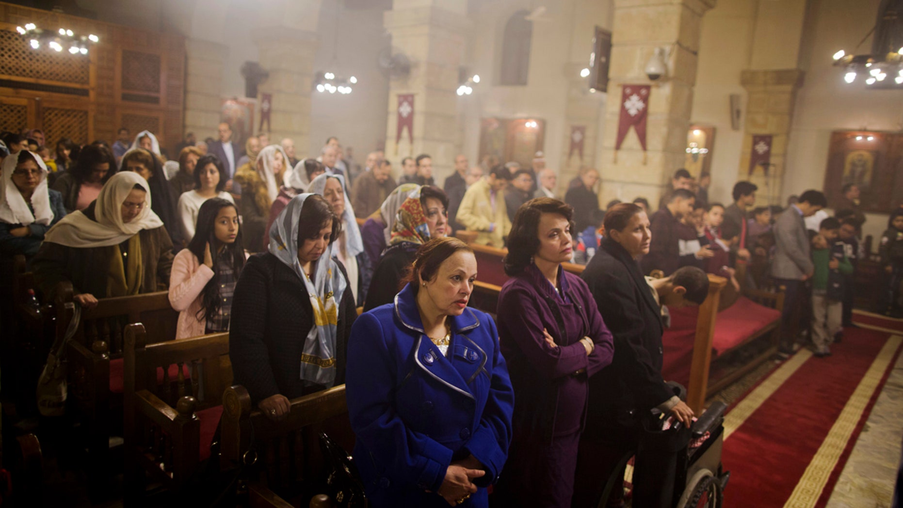 Coptic Christians pray during Christmas Eve Mass at the Virgin Mary church, in Cairo, Egypt, late Saturday, Jan. 6, 2018.