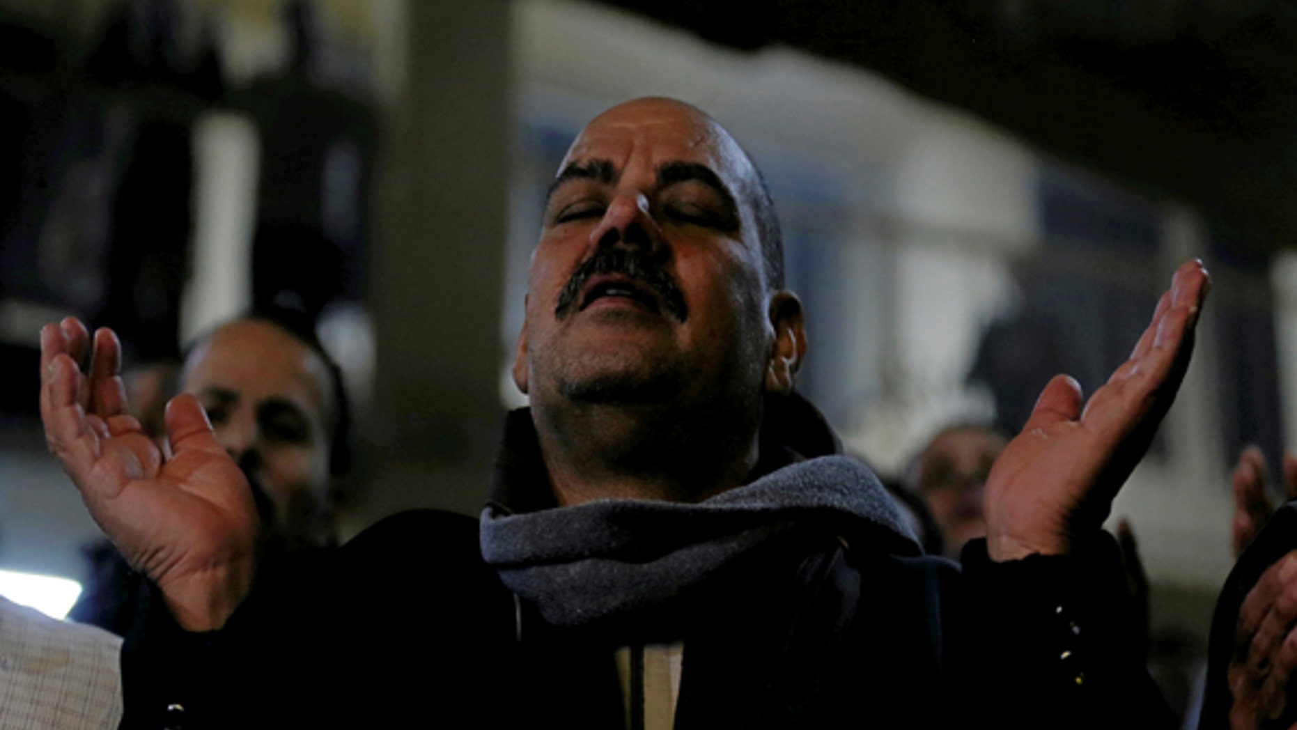 January 6, 2017: An Egyptian Christian attends Egypt's Coptic Christmas eve mass in a church of the Samaan el-Kharaz Monastery in the Mokattam Mountain area of Cairo, Egypt.
