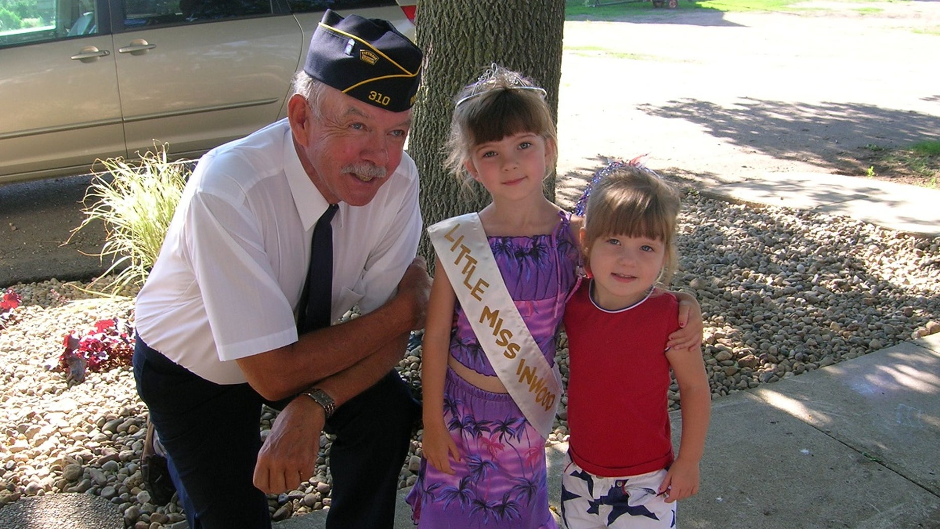 Paul and his granddaughters on the day of a Fourth of July parade.