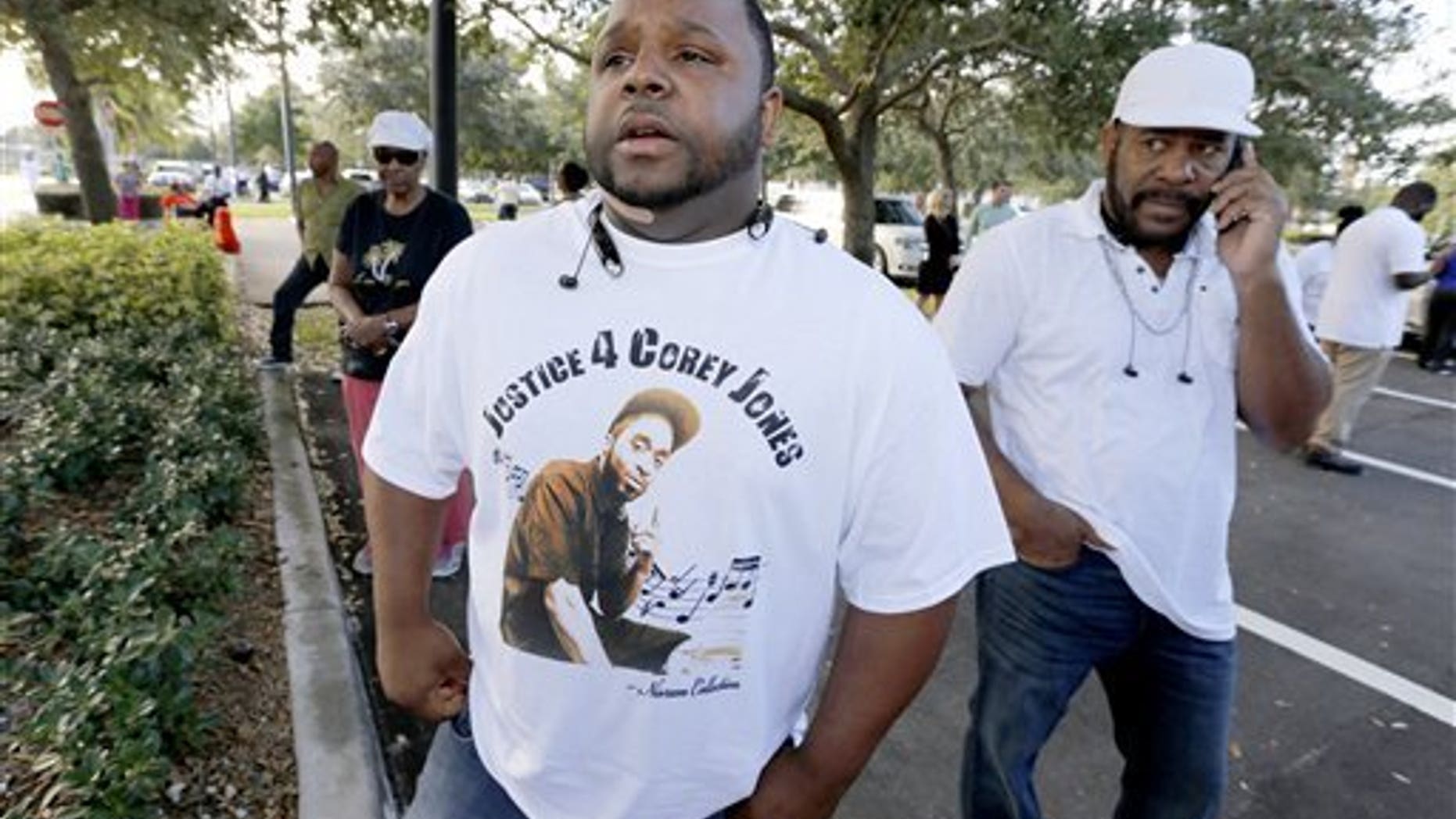 Tim Kitchens, a cousin of Corey Jones, at a rally in October.