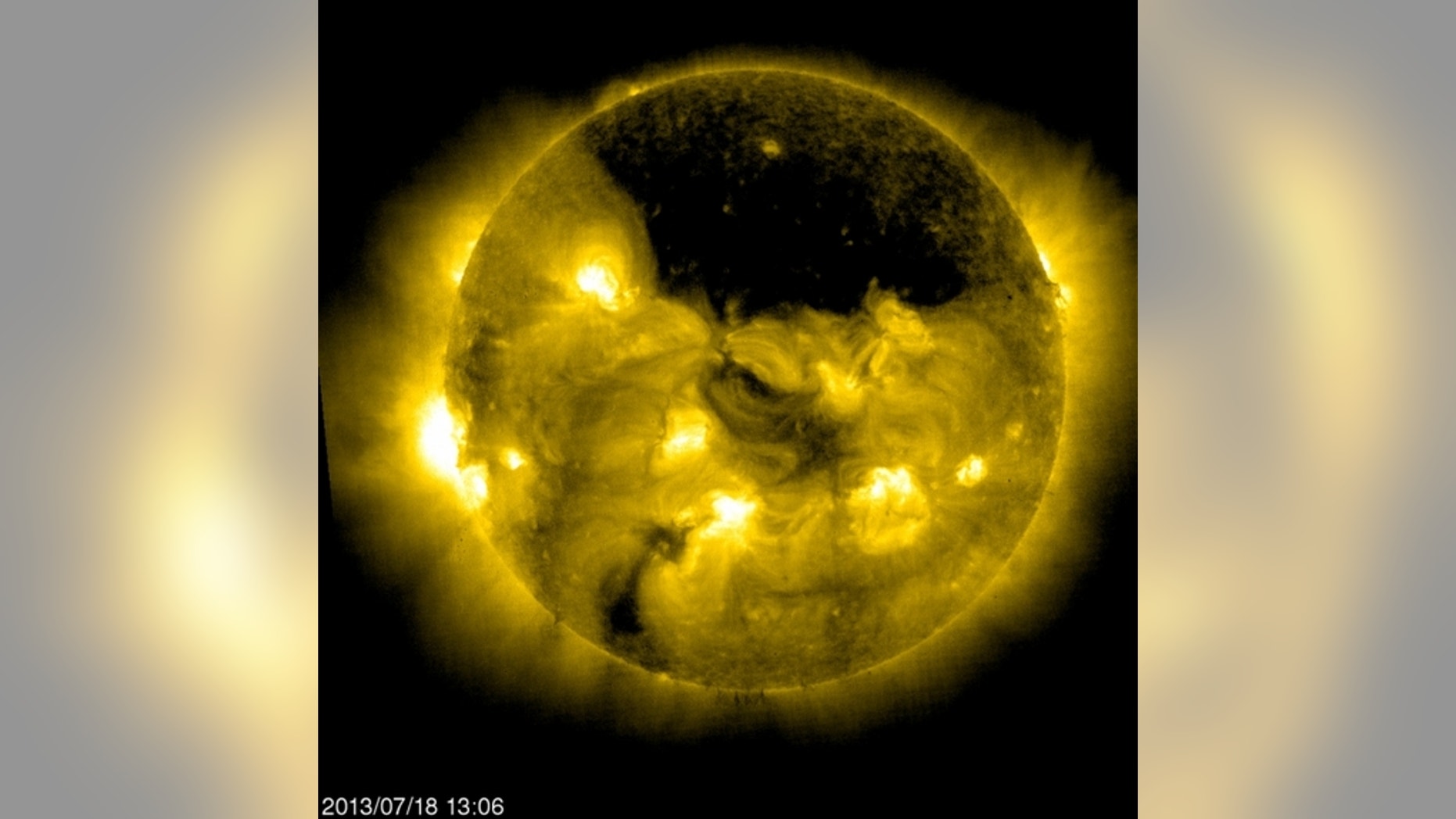 The European Space Agency/NASA Solar and Heliospheric Observatory, or SOHO, captured this image of a gigantic coronal hole hovering over the sun’s north pole on July 18, 2013, at 9:06 a.m. EDT.