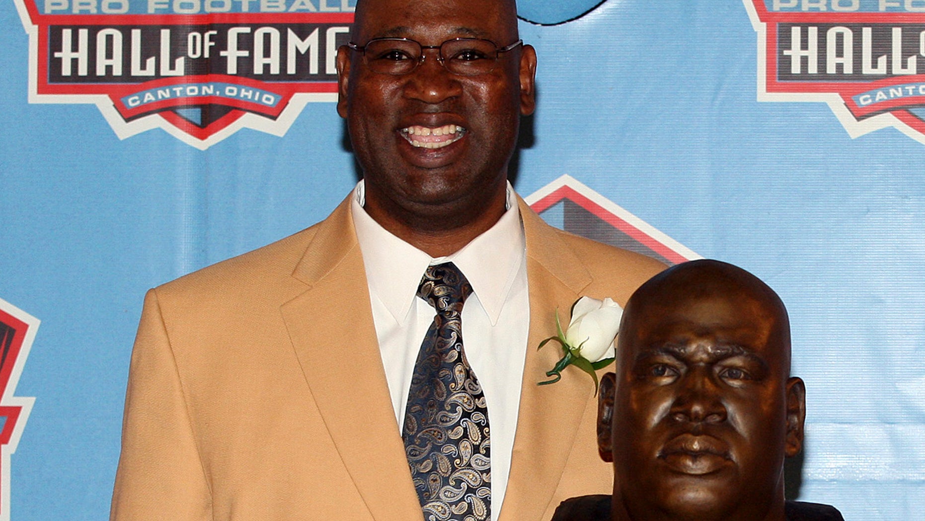 Former Seattle Seahawk Cortez Kennedy stands with his bust after being accepted into the Pro Football Hall of Fame in Canton, Ohio August 4, 2012. Kennedy was found dead on Tuesday in Orlando. REUTERS/Aaron Josefczyk