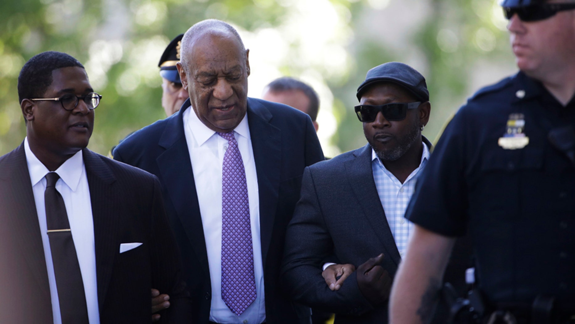 Bill Cosby arrives with Comedian Joe Torry, second from right, for his sexual assault trial at the Montgomery County Courthouse in Norristown, Pa., Friday, June 9, 2017.