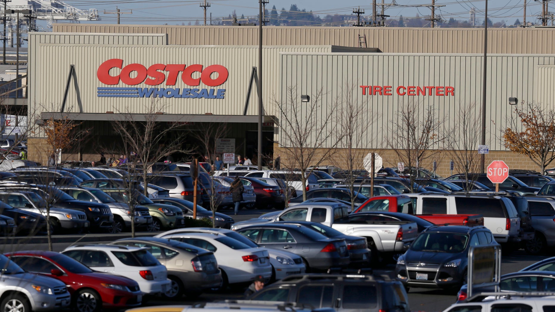 Cars fill the parking lot of a Costco store, Tuesday, Nov. 24, 2015, in Seattle. Health authorities say chicken salad from Costco has been linked to at least one case of E. coli in Washington state. (AP Photo/Ted S. Warren)