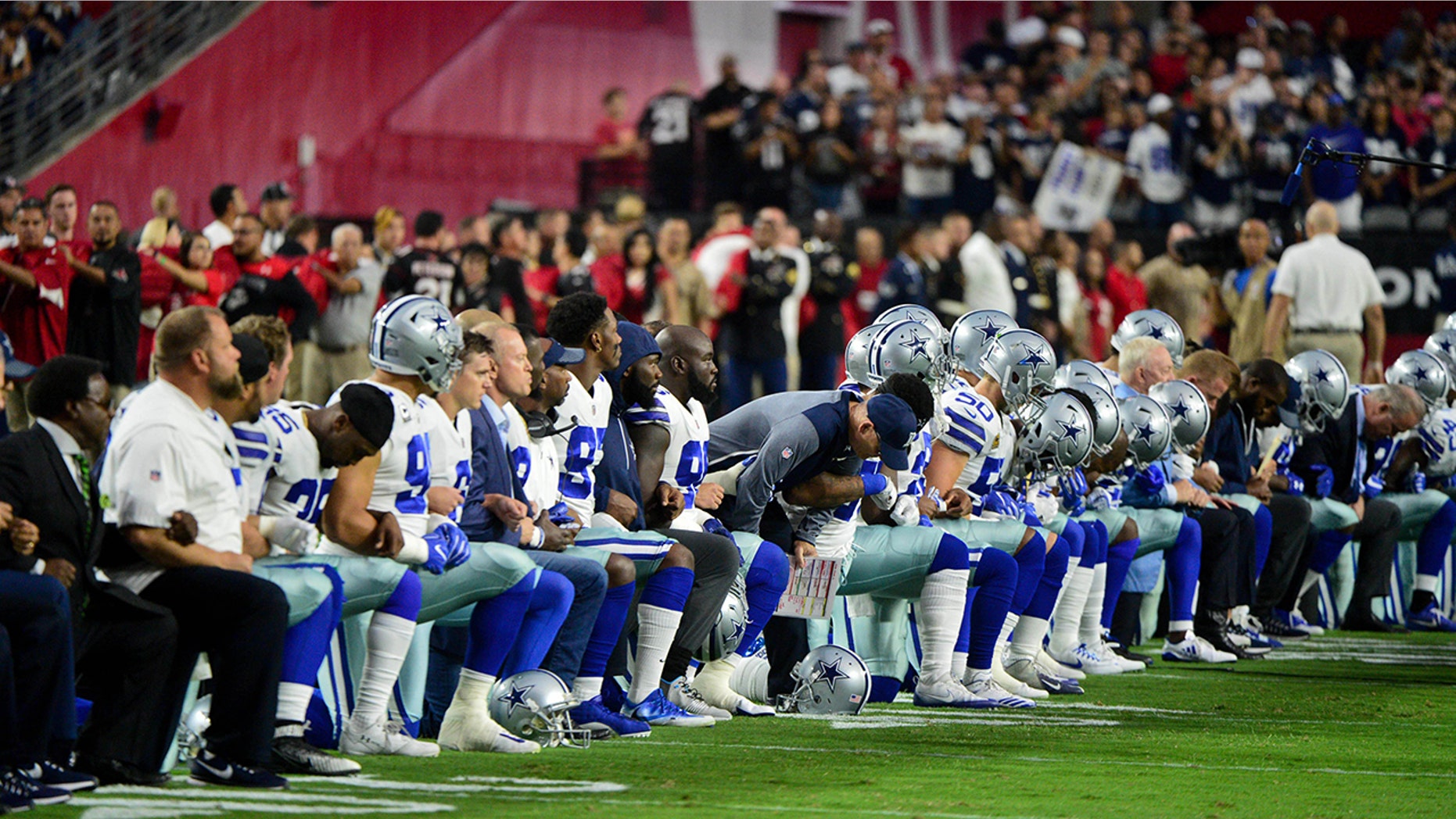 Dallas Cowboys players, coaches and staff took a knee prior to the national anthem Monday.
