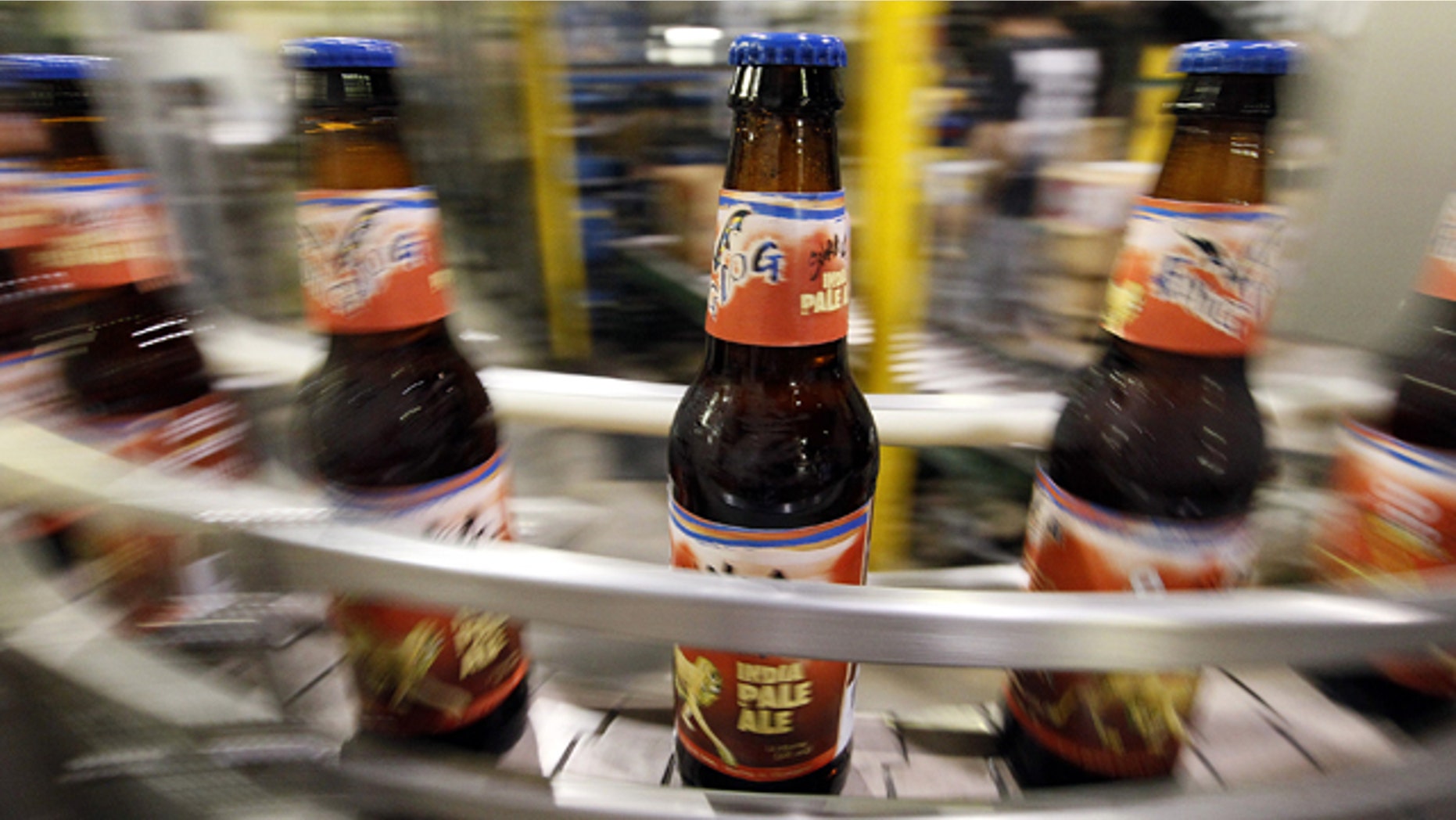 In this July 25, 2011 photo, beer bottles move along a conveyor belt after being filled at the Flying Dog Brewery in Frederick, Md. The company plans to end shipments to more than a dozen states beyond the east coast in order to burnish its image as a craft brewer and attract more consumers who are interested in buying local. (AP Photo/Patrick Semansky)