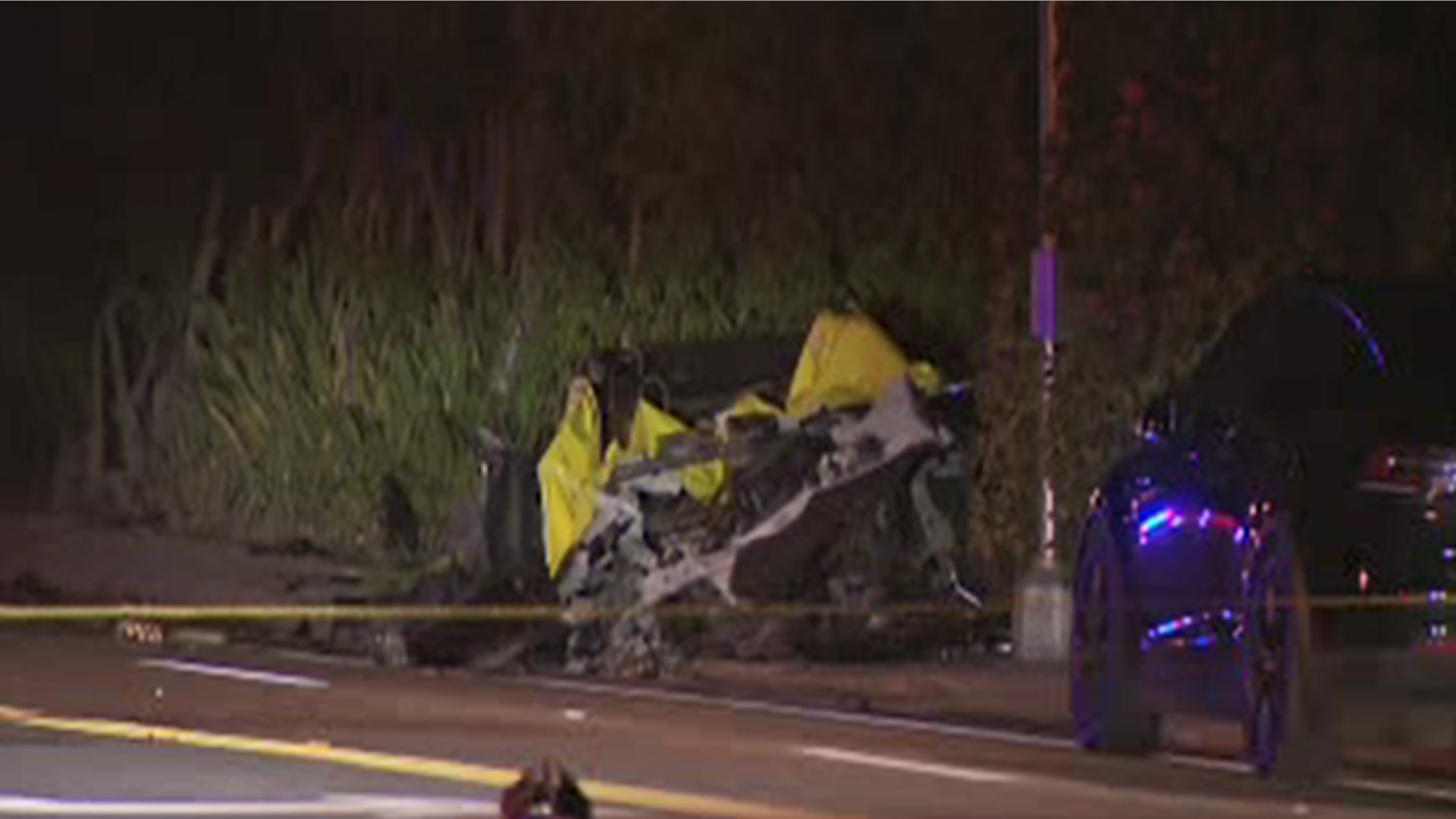 The car, which appeared to be speeding, sideswiped a concrete wall and started burning before it came to a stop and became engulfed in flames coming from its battery pack.