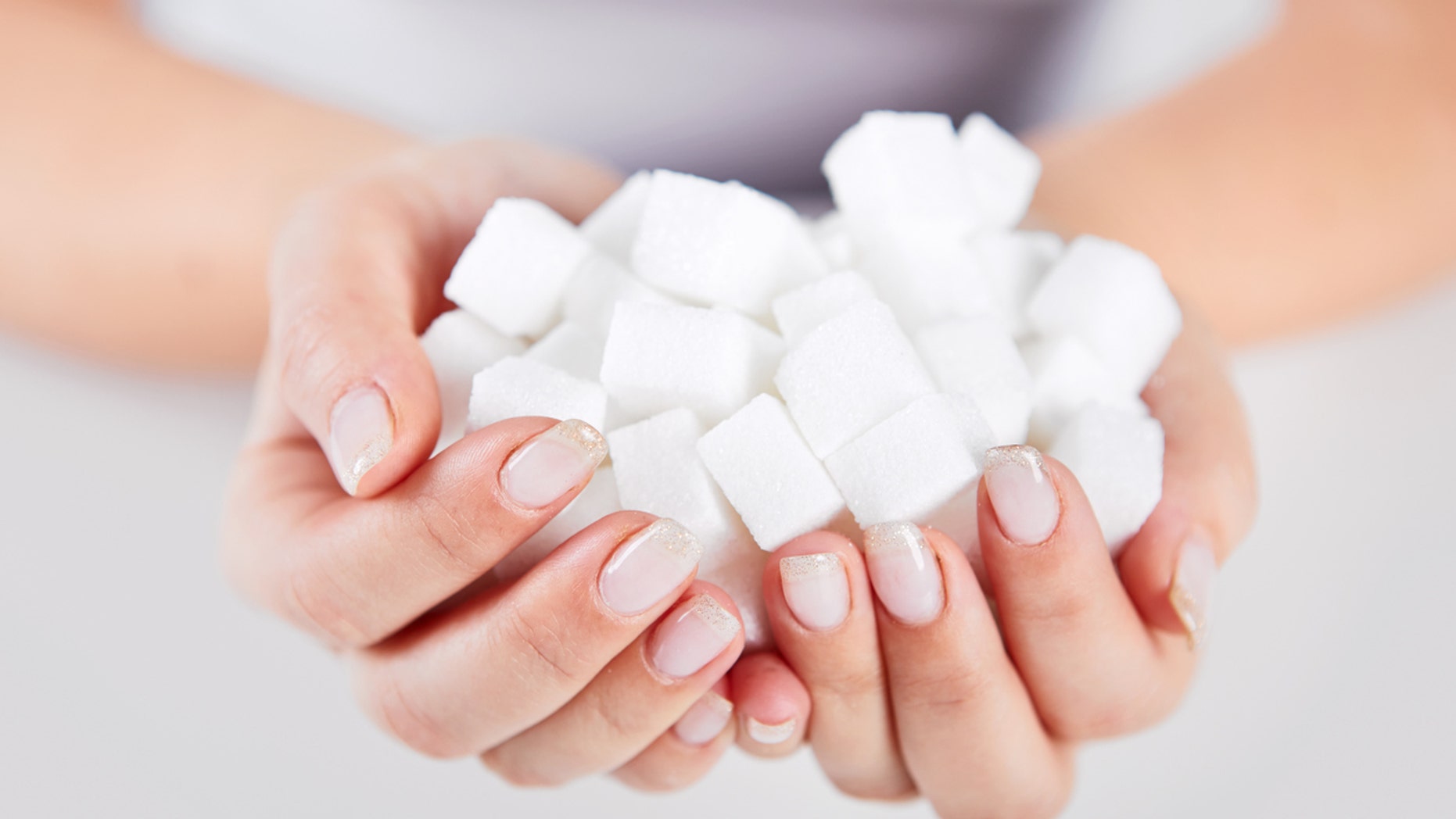 Woman holds in hands of sugar cubes