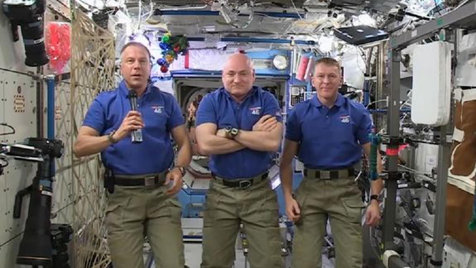 Astronauts Scott Kelly and Tim Kopra of NASA, and Tim Peake of the European Space Agency delivered a holiday message from the International Space Station on Dec. 18. The station Christmas tree can be seen just to the right of Kopra's head.