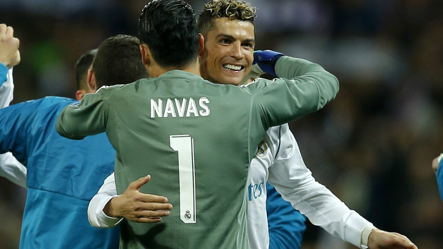 Real Madrid goalkeeper Keylor Navas, left, hugs teammate Cristiano Ronaldo after Real defeated Bayern Munich on Tuesday, to advance to the UEFA Champions League final on May 26 in Kiev, Ukraine.