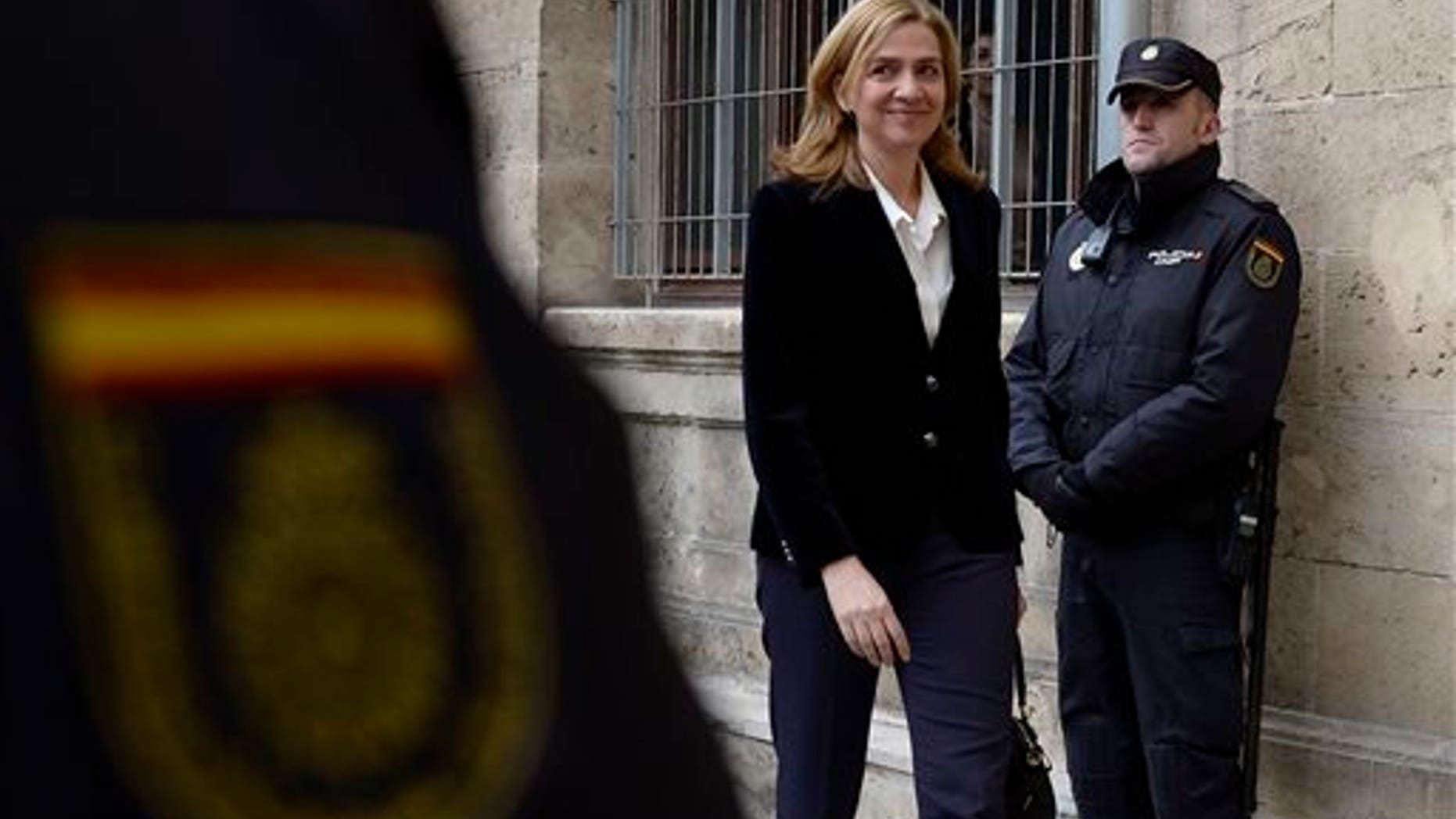 In this Feb. 8, 2014 file photo, Spain's Princess Cristina arrives at the courthouse in Palma de Mallorca, Spain after being named as a fraud and money laundering suspect. A Spanish judge on Wednesday June 25, 2014, has moved closer to indicting Princess Cristina, sister of newly proclaimed King Felipe, in a tax fraud and money laundering investigation centering on her husband. Wrapping up a four-year pre-trial investigation, Palma de Mallorca investigative magistrate Jose Castro kept Cristina on the list of suspects he thinks should stand trial, in her case for money laundering and tax fraud cooperation.
