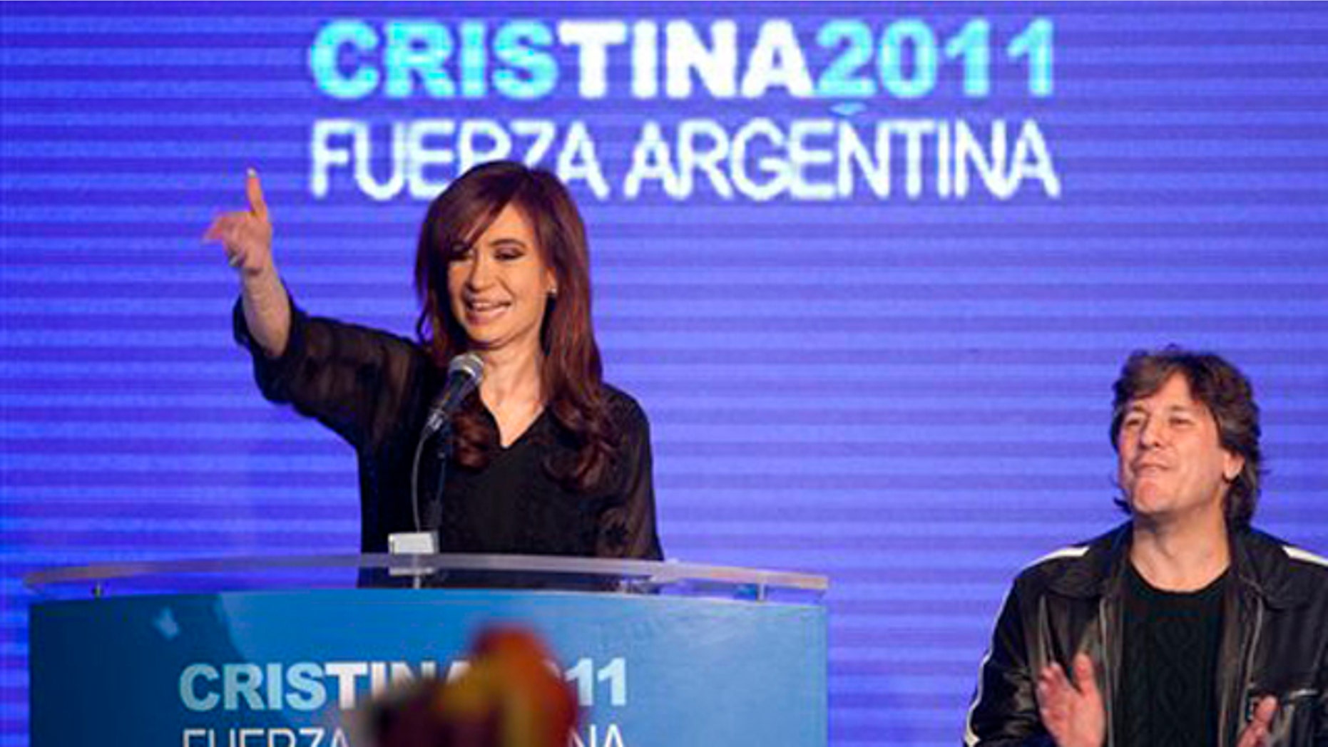 Argentina's President and candidate for re-election Cristina Fernandez, left, and Amado Boudou, Argentina's Minister of Economy and vice-presidential candidate, celebrate with supporters after the primary elections in Buenos Aires, Argentina, Sunday Aug. 14, 2011.