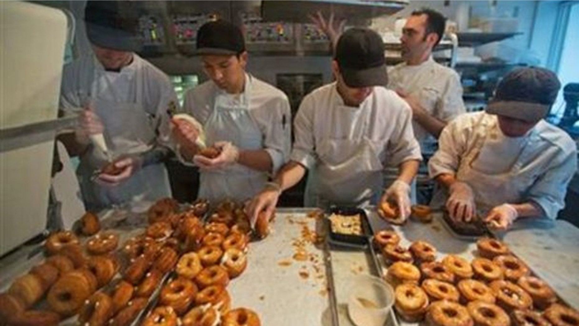 FILE: A baking crew makes Cronuts, a croissant-donut hybrid, at the Dominique Ansel Bakery in New York.