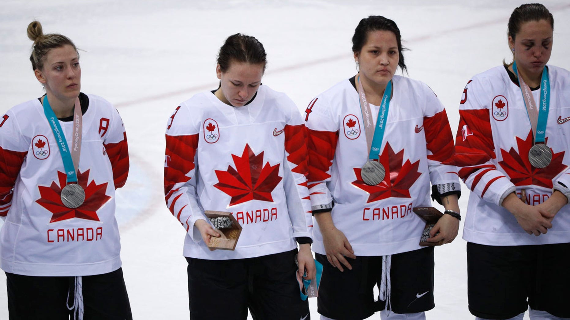 FILE: Jocelyne Larocque of Canada holds her silver medal in her hand, next to teammates wearing their medals during the medal ceremony.