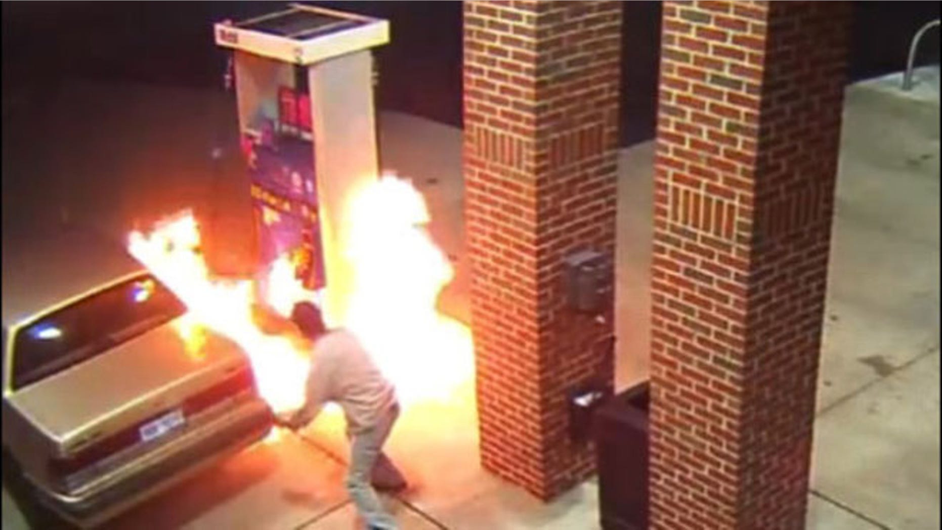 Image from surveillance video shows motorist starting gas station blaze trying to kill spider with lighter.