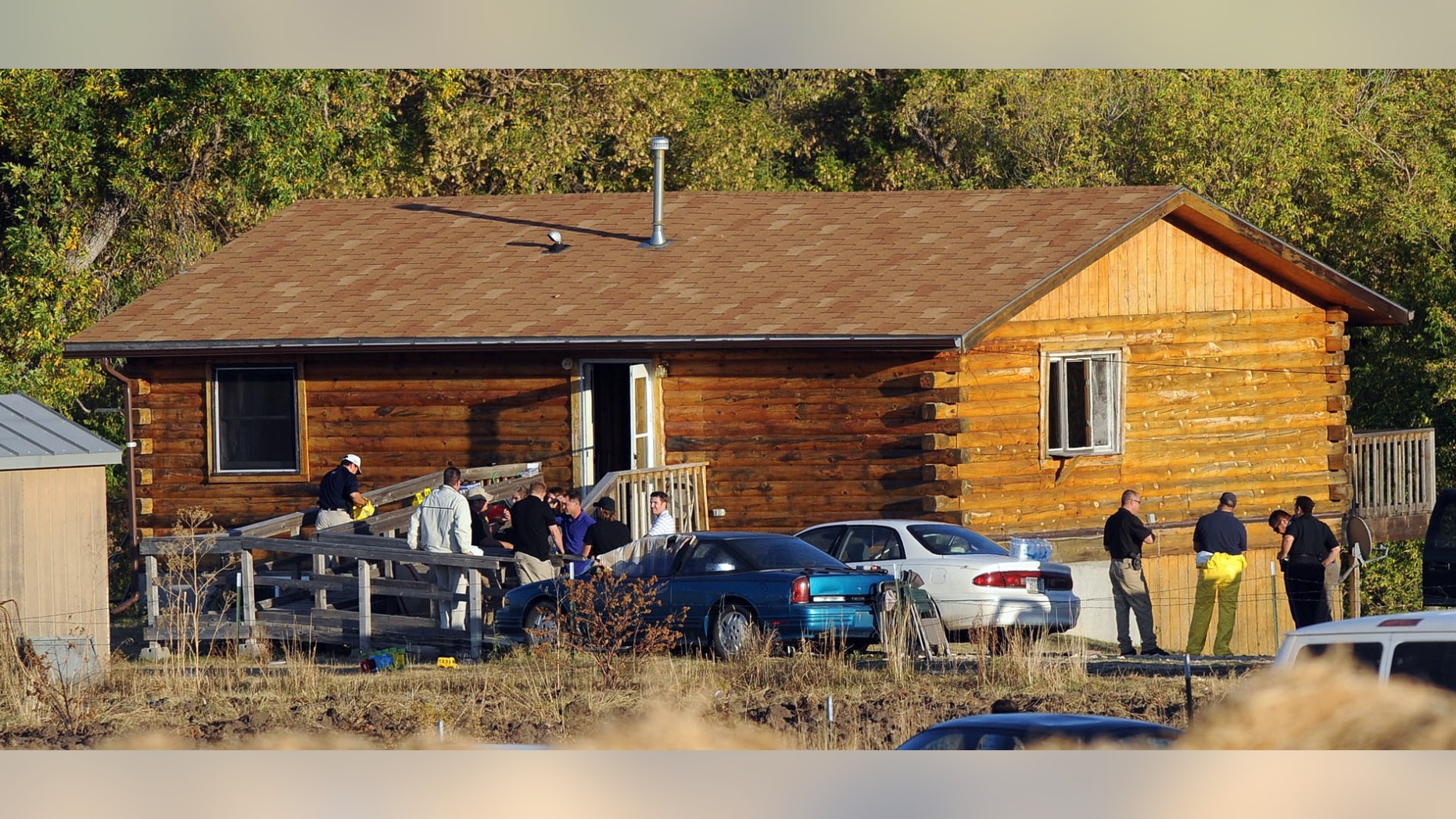 Oct. 4: Law enforcement officers remove a shooting victim's body from a home about nine miles south west of Lodge Grass near Montana's Crow Reservation. A shooting left three people dead at a rural residence on Montana's Crow Reservation.