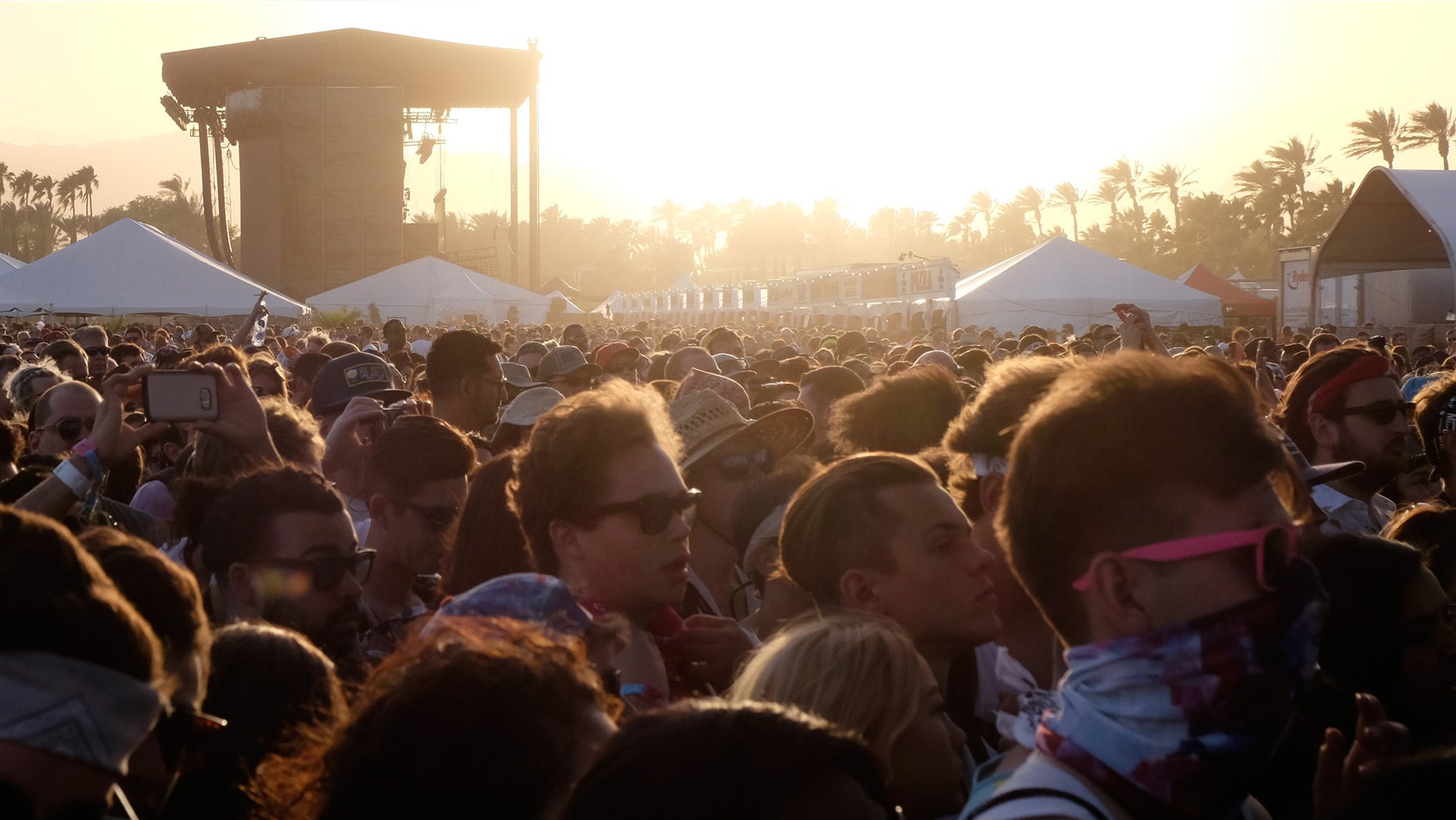 INDIO, CA - APRIL 15: Festival goers at sunset during day 1 of the 2016 Coachella Valley Music & Arts Festival Weekend 1 at the Empire Polo Club on April 15, 2016 in Indio, California. (Photo by Frazer Harrison/Getty Images for Coachella)