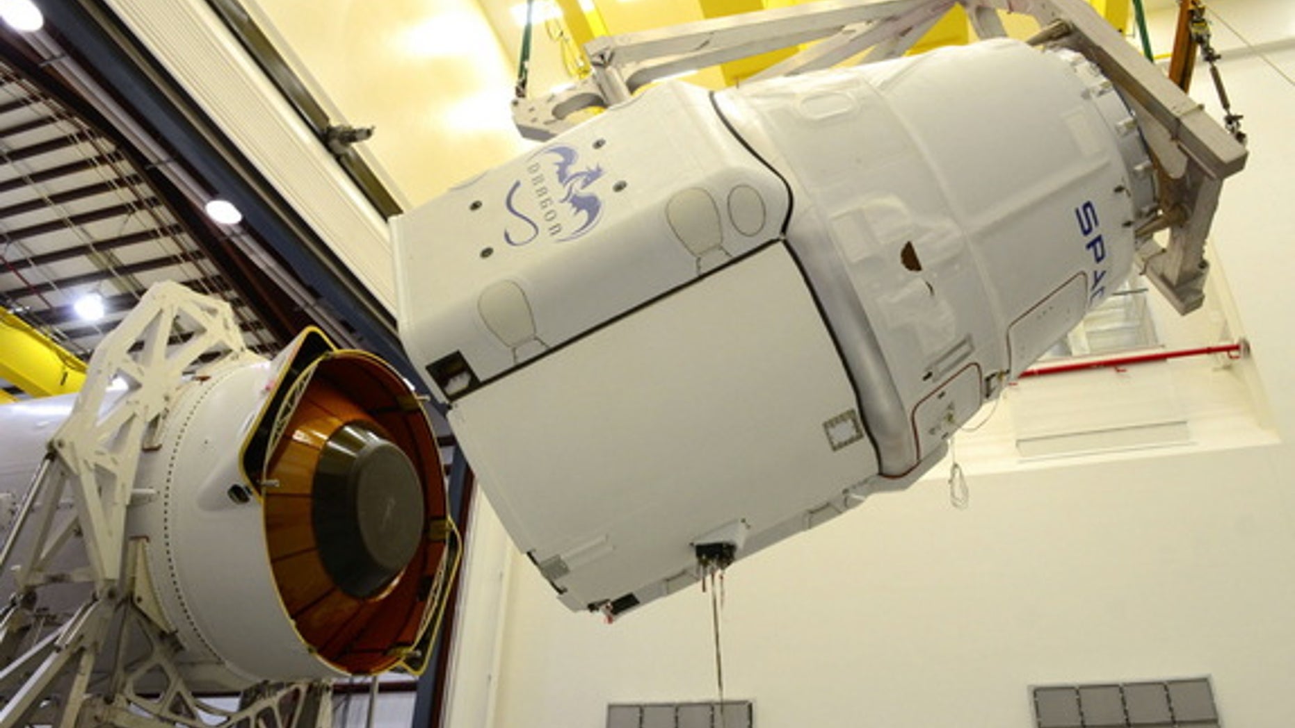 A SpaceX robotic Dragon space capsule is mated to the top of its Falcon 9 rocket ahead of a planned March 2014 launch to the International Space Station from Cape Canaveral Air Force Station, Florida. Image released March 11.