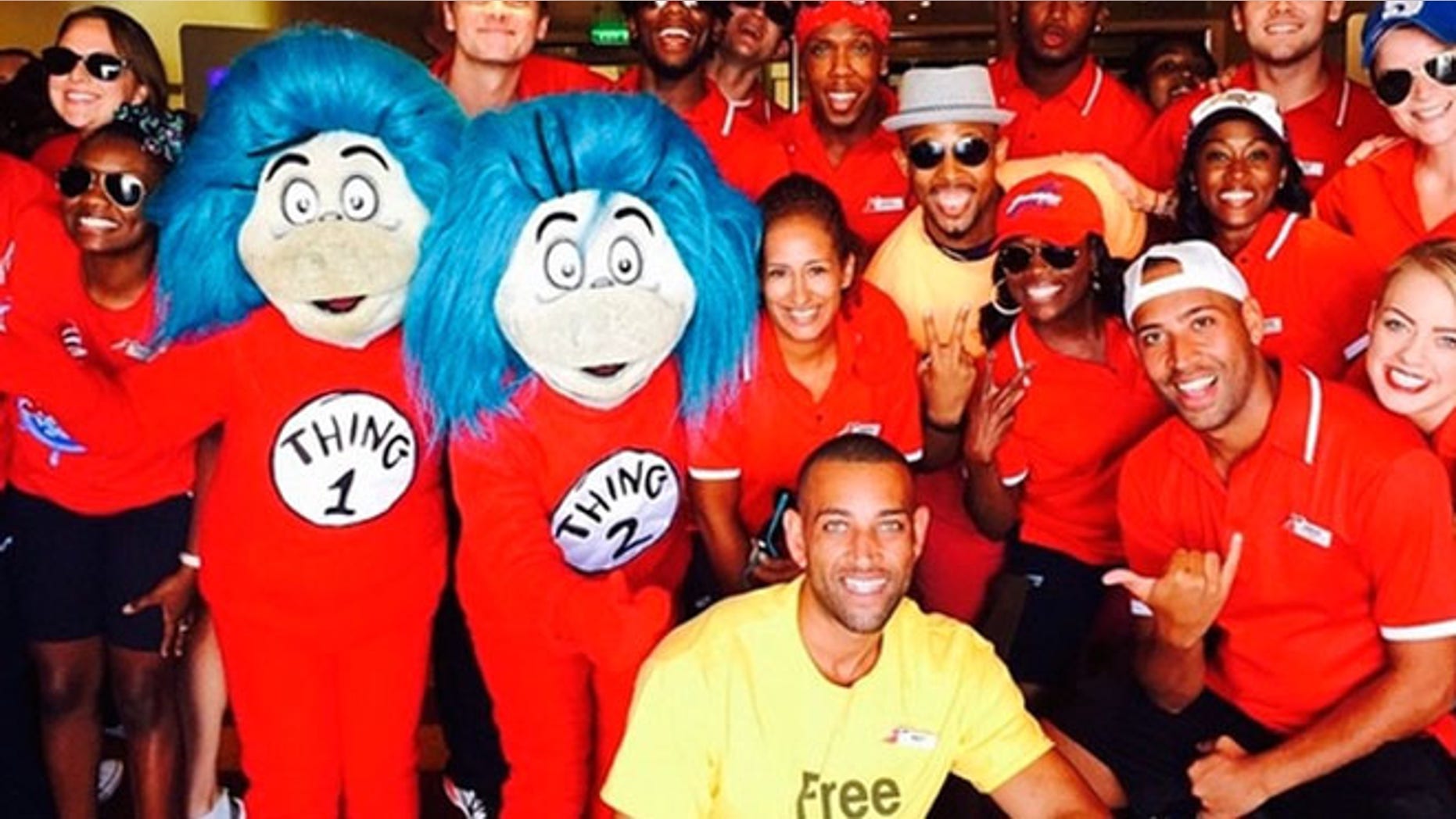 Carnival Breeze cruise director Matt Mitcham (in the yellow "Free Hugs" shirt) with his entertainment staff and a couple of special guests.