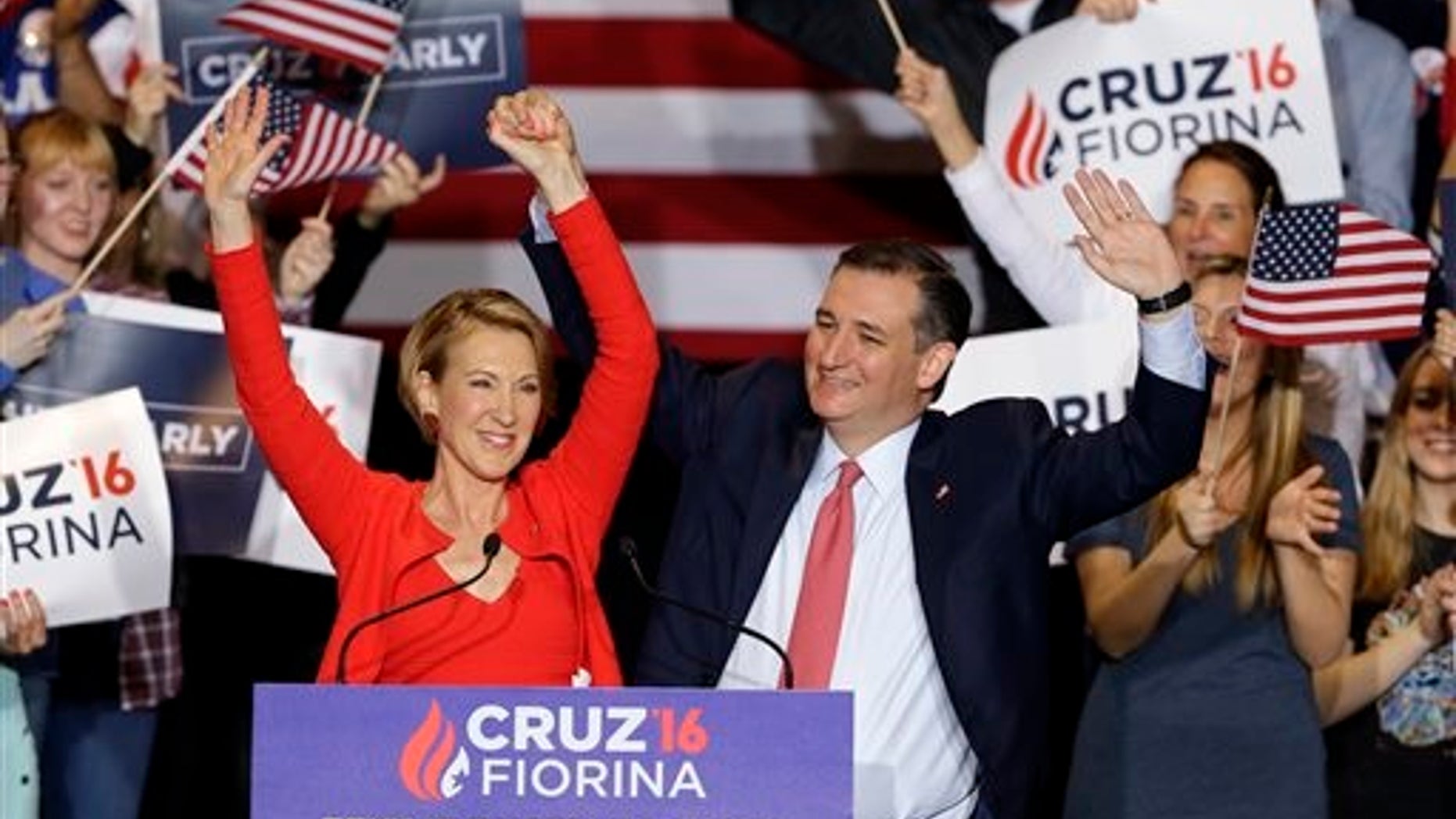 Republican presidential candidate Sen. Ted Cruz, R-Texas, joined by former Hewlett-Packard CEO Carly Fiorina, waves during a rally in Indianapolis, Wednesday, April 27, 2016, when Cruz announced he has chosen Fiorina to serve as his running mate. (AP Photo/Michael Conroy)