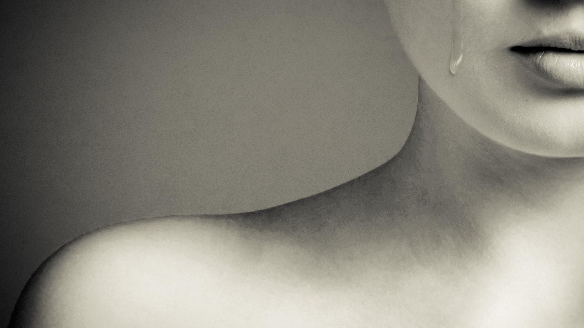 Close up of young girls face with a single tear rolling down on cheek