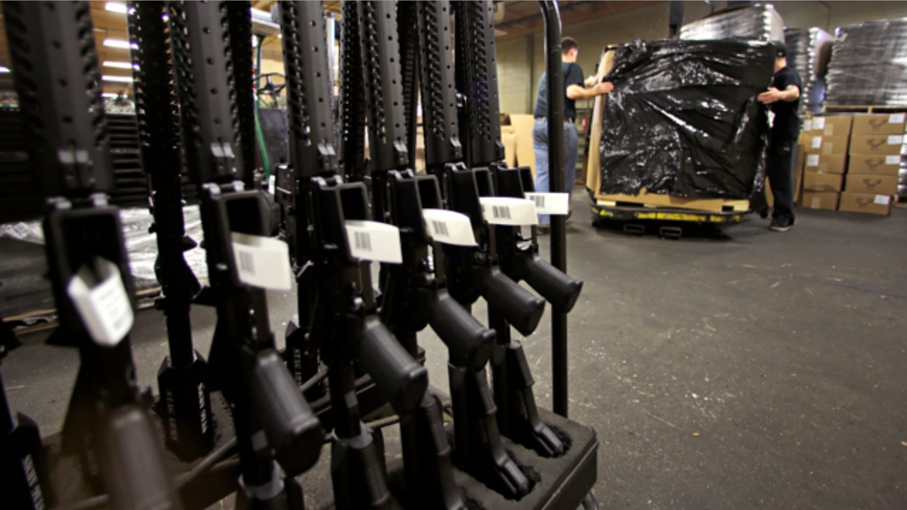 April 10, 2013: A rack of AR-15 rifles stand to be individually packaged as workers move a pallet of rifles for shipment at the Stag Arms company in New Britain, Conn.