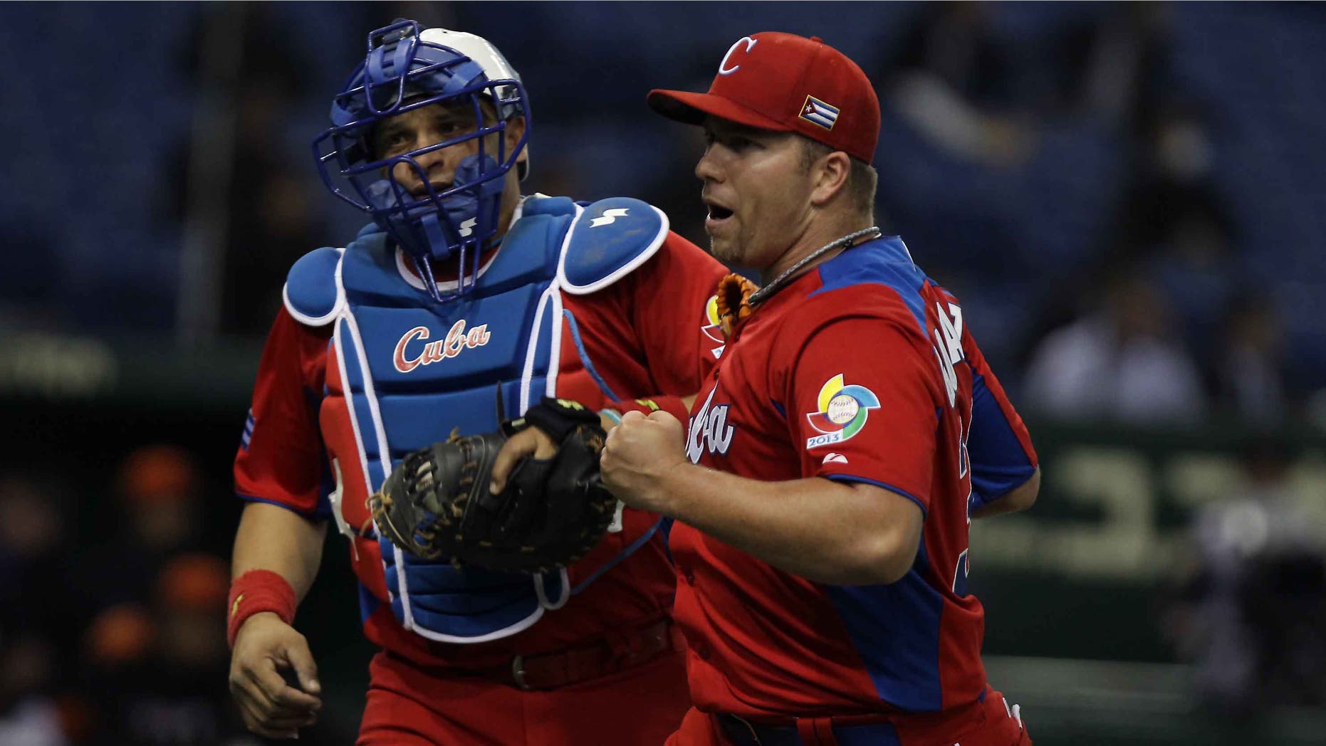 Pitcher Norberto Gonzalez and catcher Eriel Sanchez of Cuba on March 11, 2013 in Tokyo, Japan.