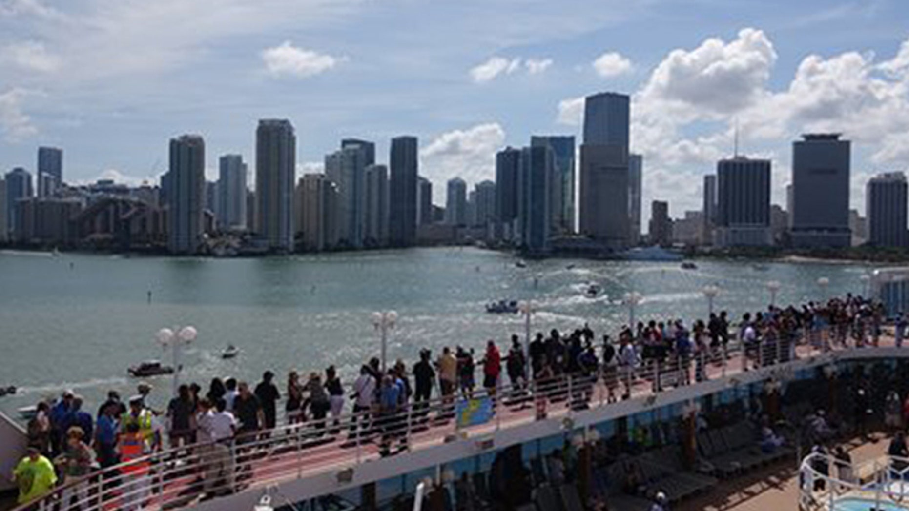 Passengers on board the Adonia watch as the ship leaves port in Miami, Sunday, May 1, 2016, en route to Cuba. After a half-century of waiting, passengers finally set sail on Sunday from Miami on an historic cruise to Cuba. (Joe Cavaretta/South Florida Sun-Sentinel via AP)