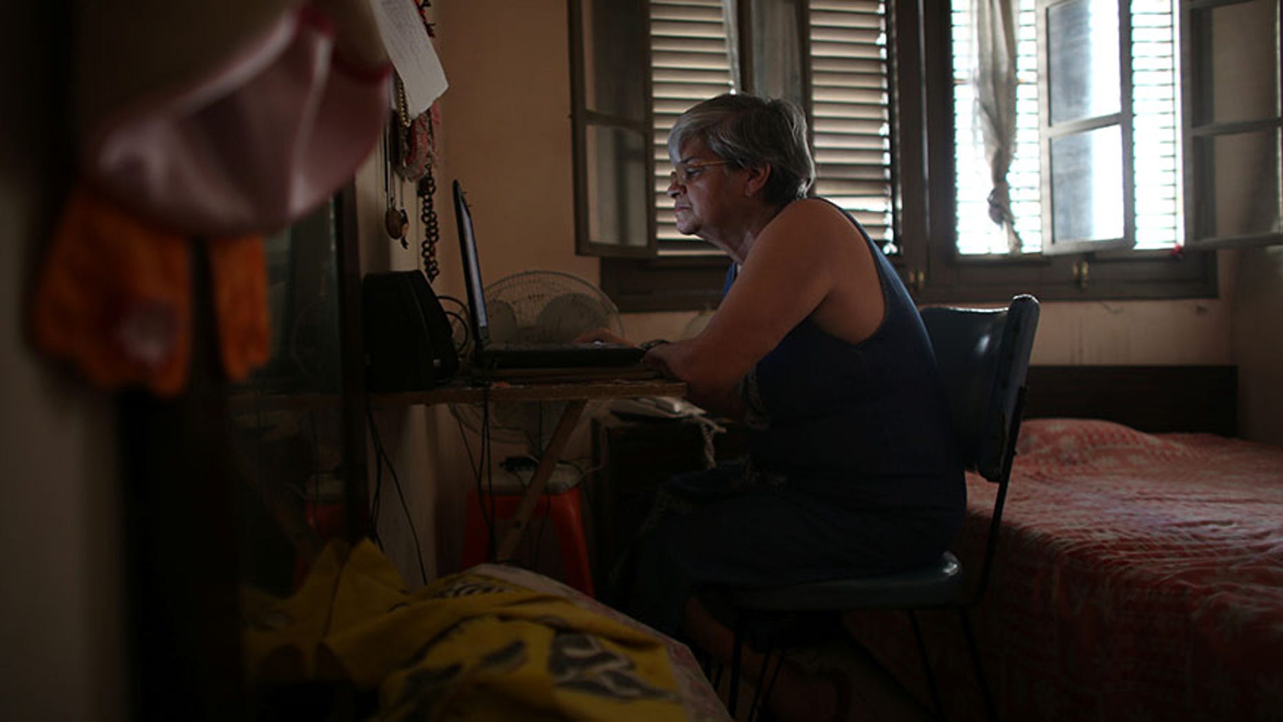 Retired teacher Margarita Marquez uses Internet recently installed at her home in Old Havana, Cuba, Dec. 29, 2016.
