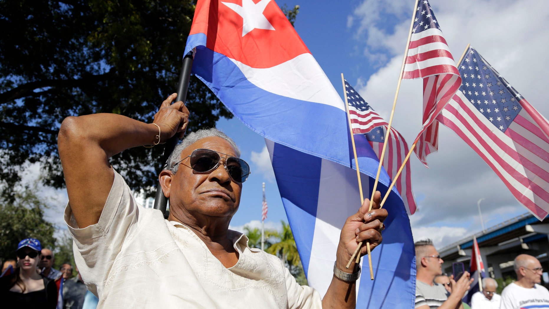 Dec. 20, 2014: Evilio Ordonez holds Cuban and American flags during a protest against President Barack Obama's plan to normalize relations with Cuba, in the Little Havana neighborhood of Miami.