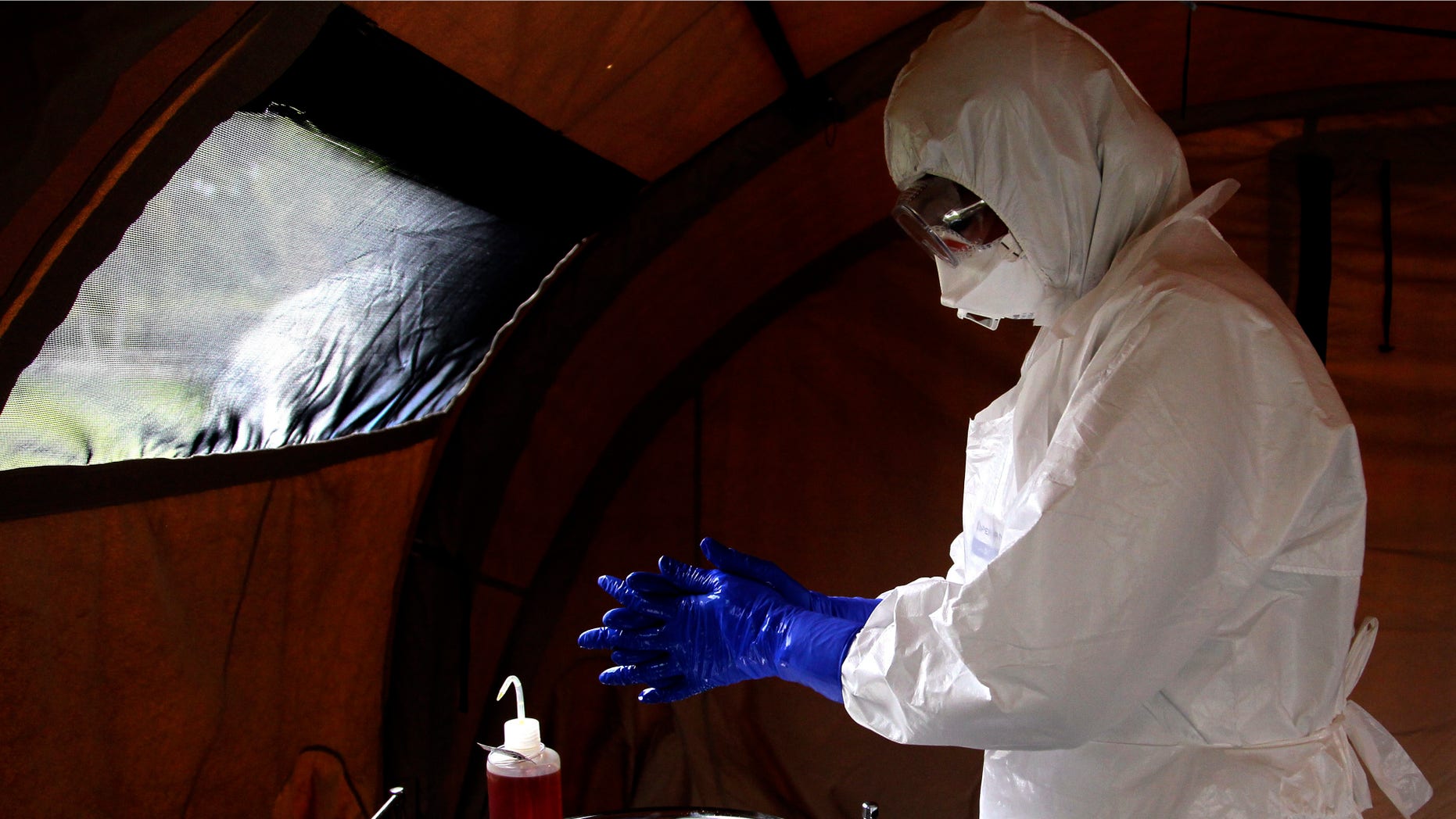 Sept. 24, 2014: nurse Dalila Martinez, trainer of the Cuban medical team to travel to Sierra Leone, washes her gloved hands during a practice drill at a training camp, in Havana, Cuba