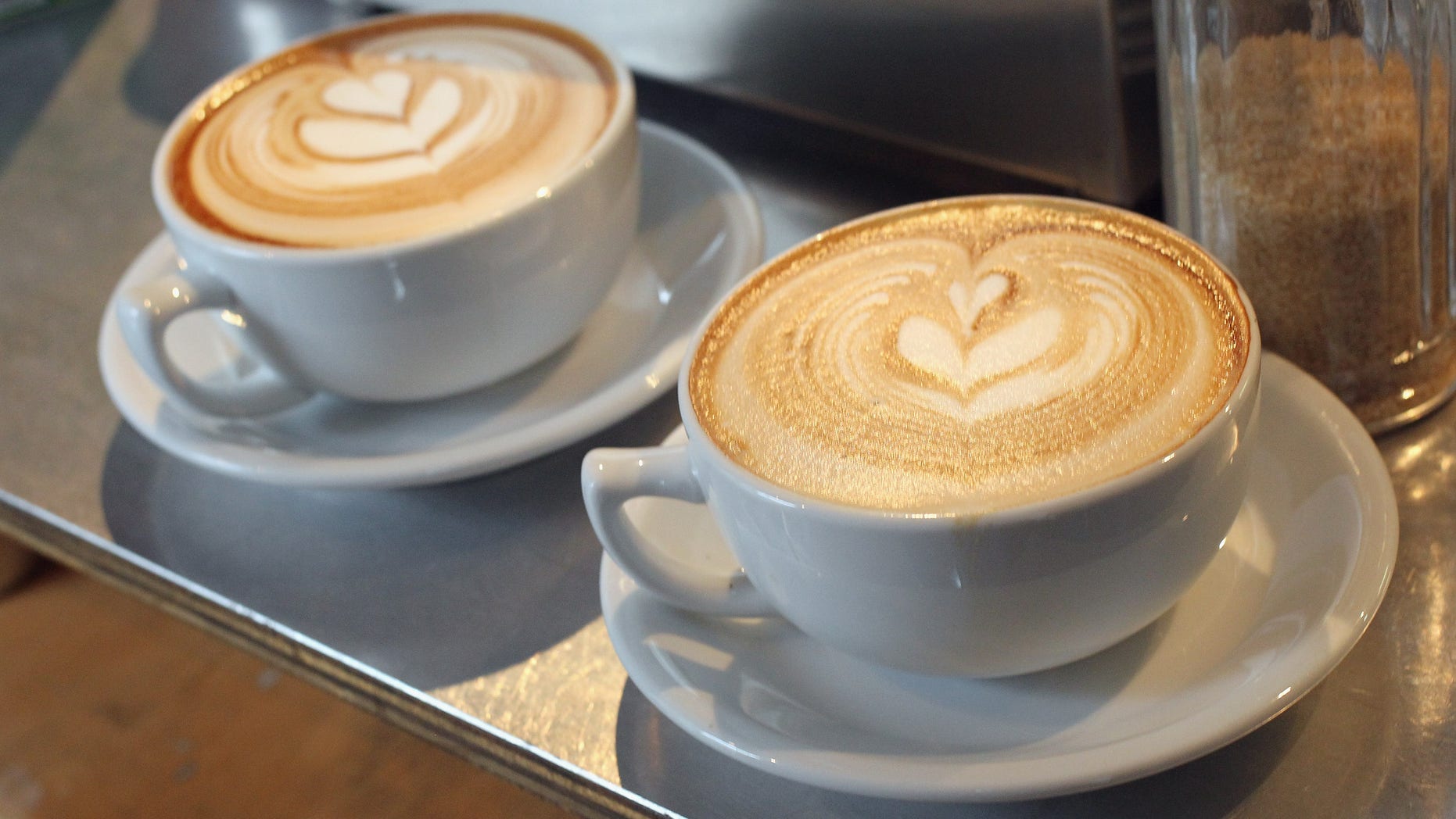 BERLIN, GERMANY - JANUARY 24: Cups of just-brewed flat white, a variation on the classic cappuccino, stand on a counter at Bonanza Coffee Roasters on January 24, 2011 in Berlin, Germany. Bonanza founder Kiduk Reus is among a growing number of so-called third wave artisinal coffee bean roasters who are finding a niche market in Europe and the USA for their carefully-crafted and expensive coffee. Reus insists that the cast iron parts, the slow-roasting abilities and hands-on controls of his flame-roasting, refurbished 1918 Probat machine allow him to develop the most flavour from his carefully selected beans. (Photo by Sean Gallup/Getty Images)