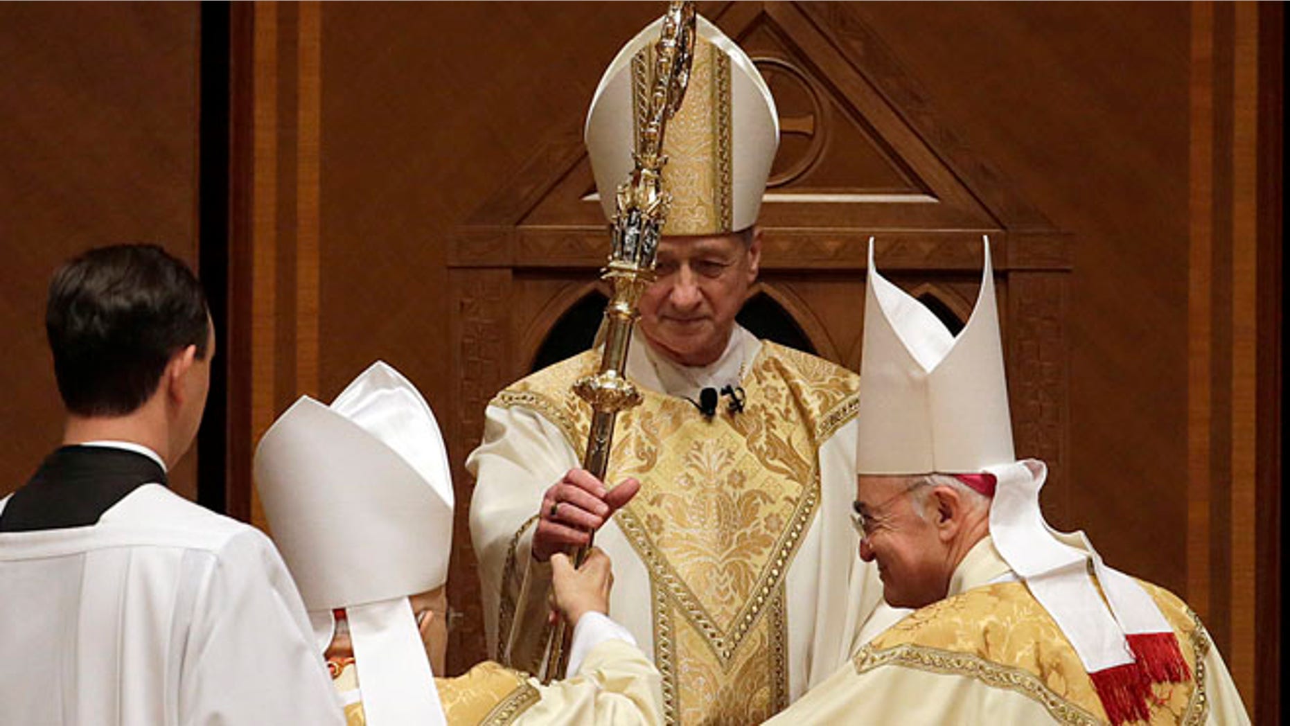 Nov. 18, 2014: The retiring Cardinal Francis George presents the crozier to the Archbishop Blase Cupich during his Installation Mass at Holy Name Cathedral in Chicago. (AP)
