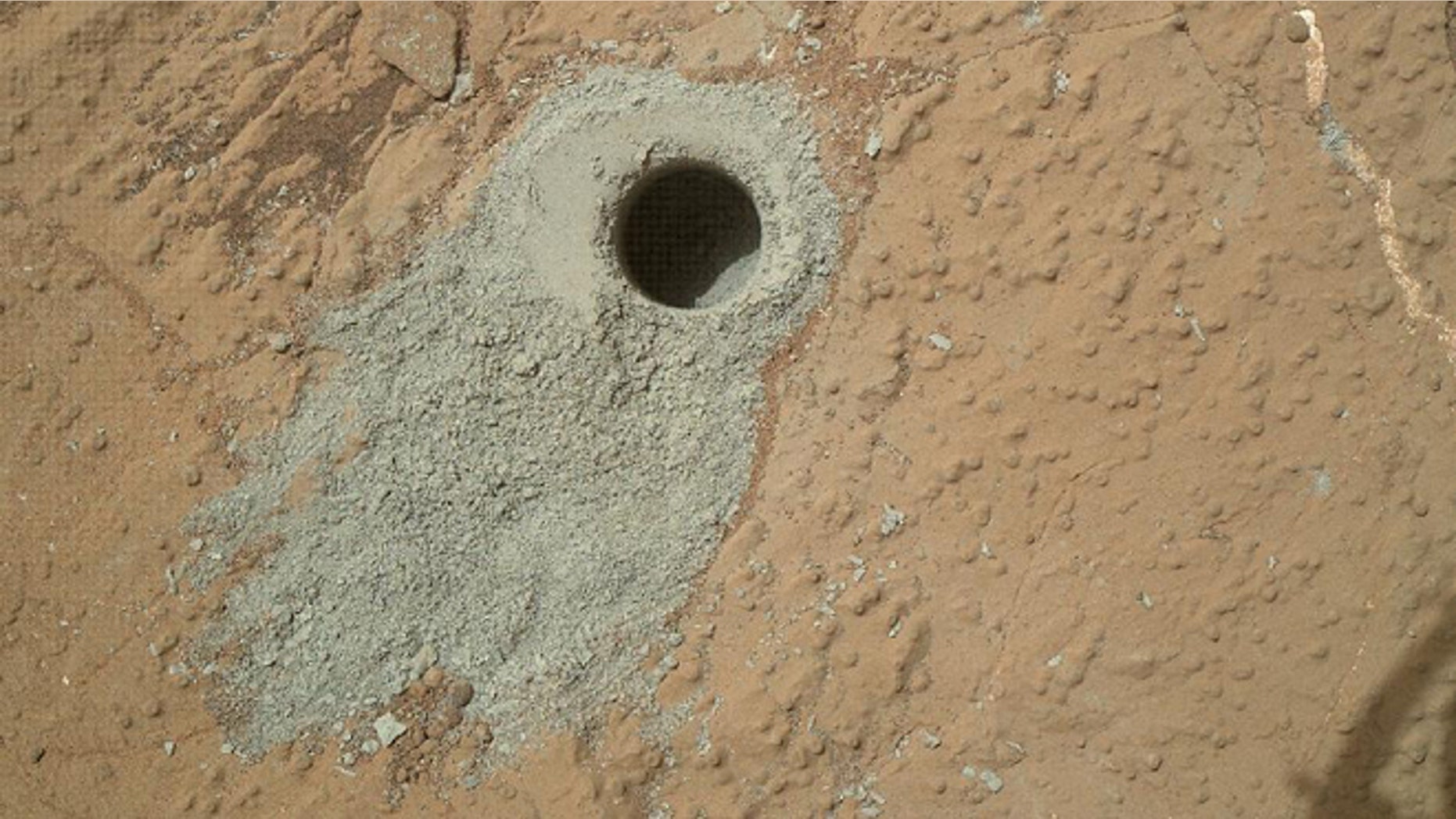 May 19, 2013: NASA's Mars rover Curiosity drilled into this rock target, "Cumberland," during the 279th Martian day, or sol, of the rover's work on Mars and collected a powdered sample of material from the rock's interior.