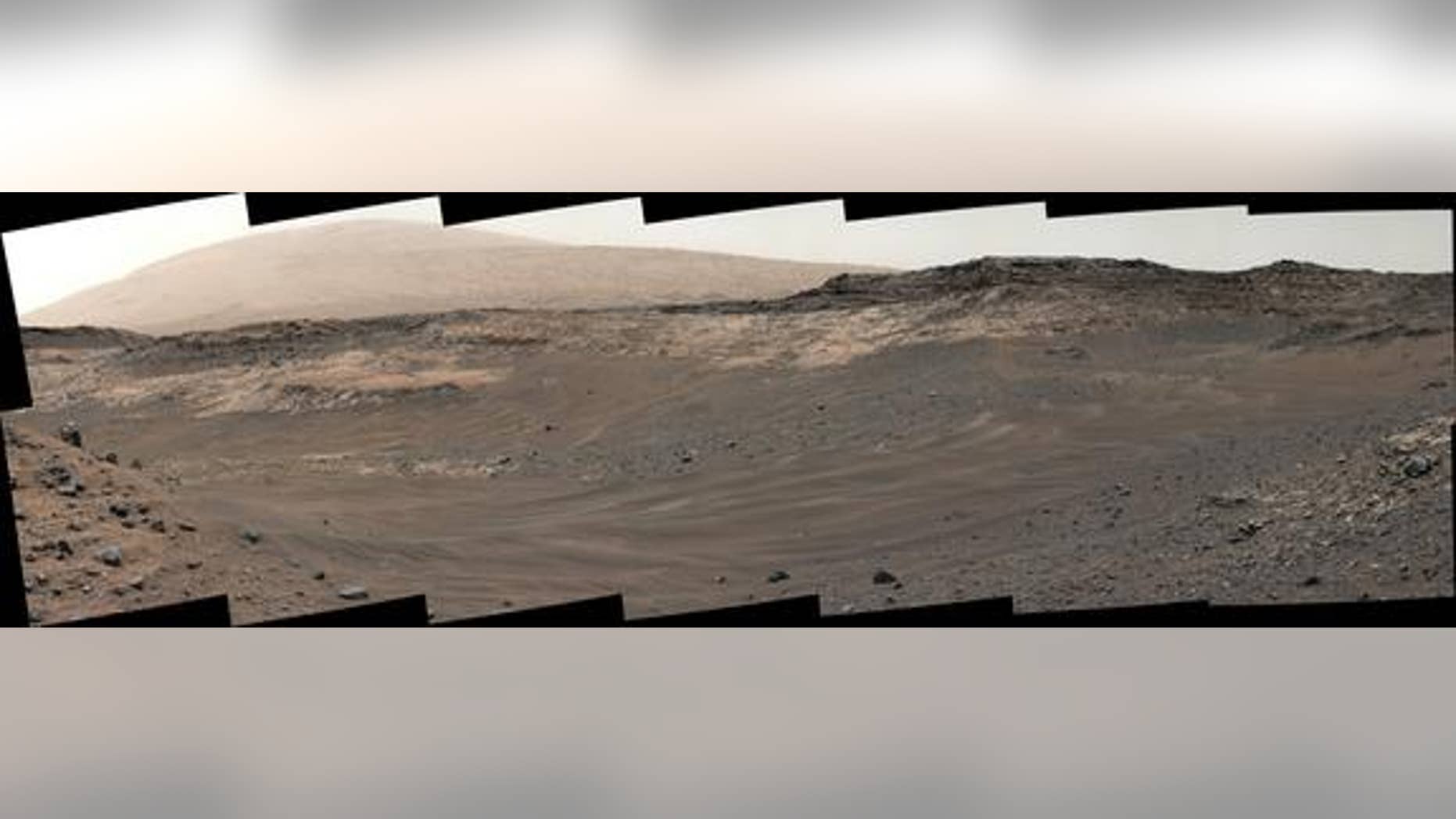 This image, captured by NASA’s Mars rover Curiosity on May 10, 2015, shows rough terrain on the way to an outcrop (light-colored rock in middle distance). Curiosity’s handlers decided not to traverse this terrain and took a different route inst