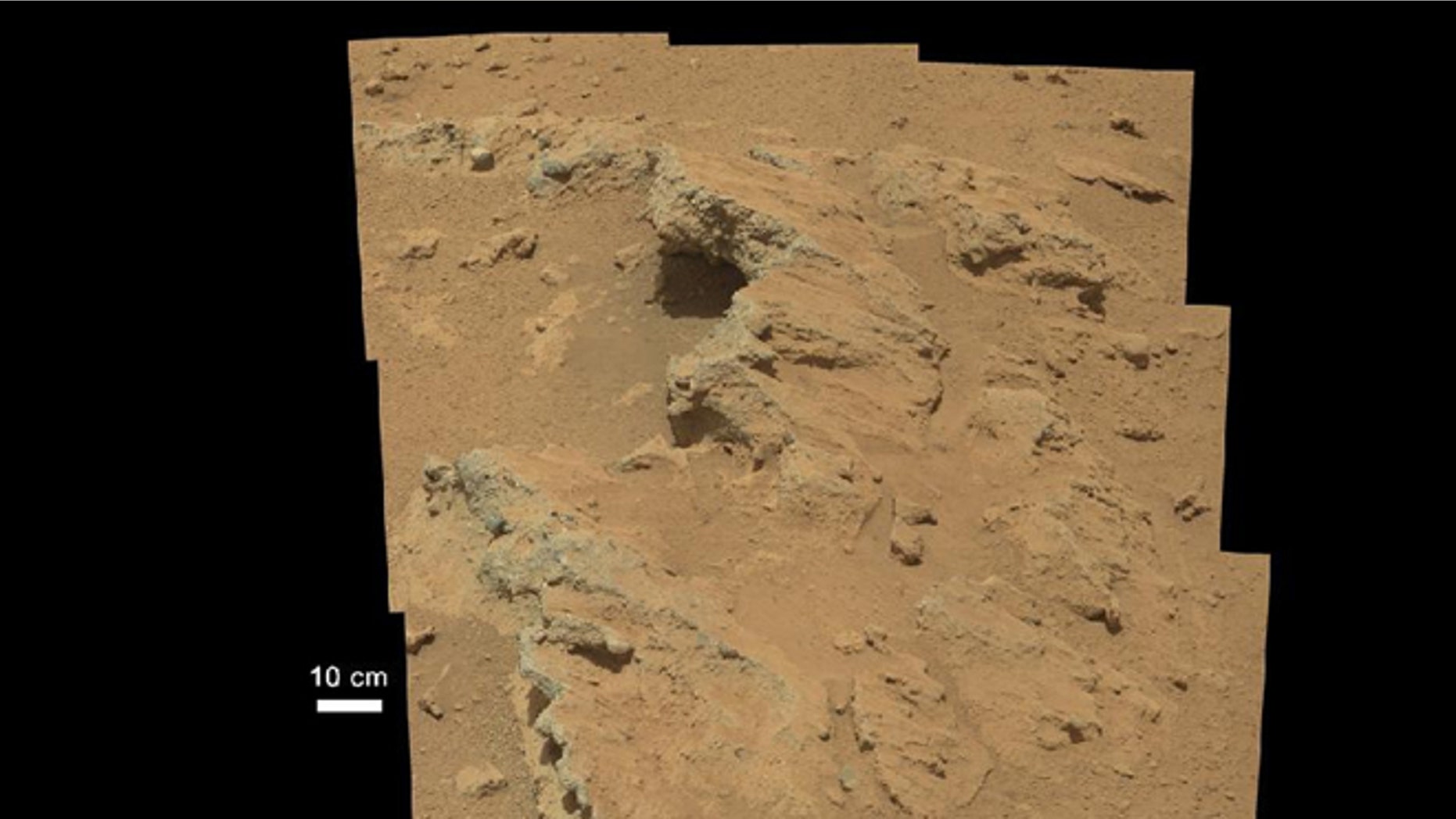 This image provided by NASA shows shows a Martian rock outcrop near the landing site of the rover Curiosity thought to be the site of an ancient streambed.