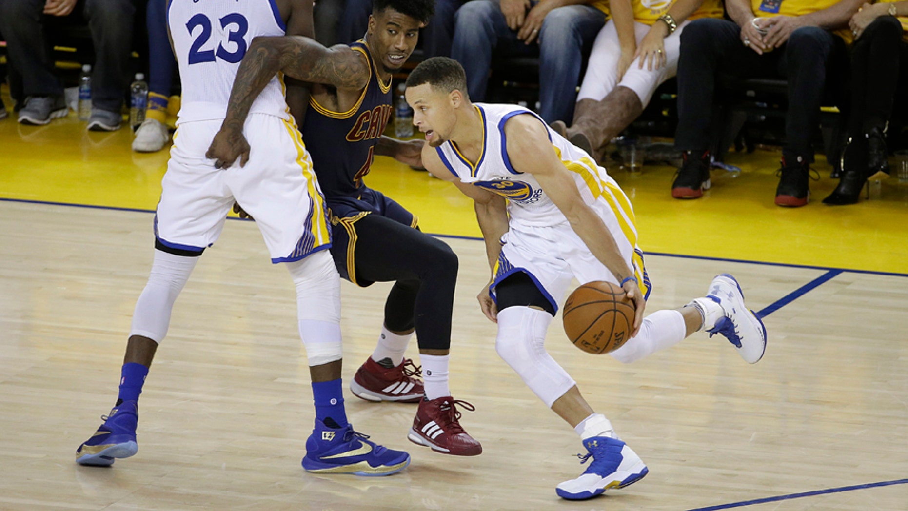 June 5, 2016: Golden State Warriors guard Stephen Curry (30) dribbles as forward Draymond Green (23) blocks Cleveland Cavaliers guard Iman Shumpert during the second half of Game 2 of basketball's NBA Finals in Oakland, Calif.