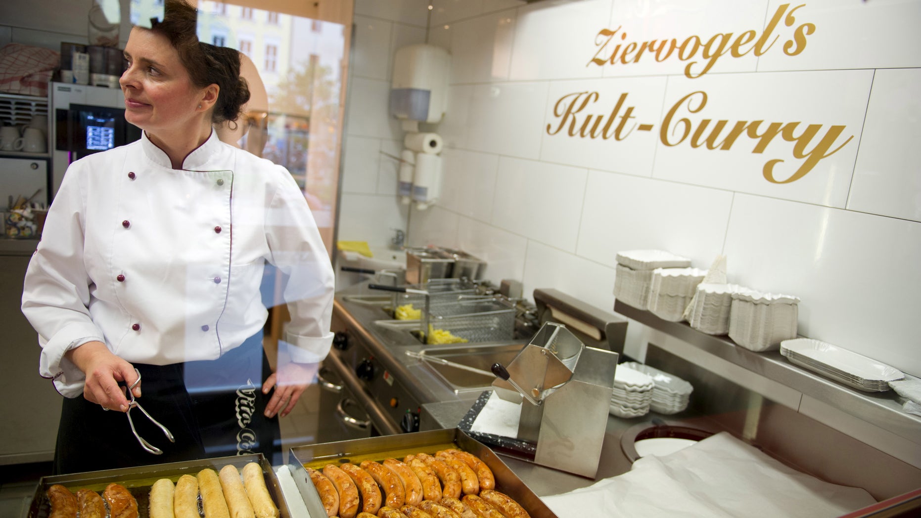Viola Ziervogel, wife of the owner Mario Ziervogel fries curried sausage, also known as Curry-wurst, at Ziervogels Kult Curry in Berlin, Germany, April 28, 2015. REUTERS/Stefanie Loos