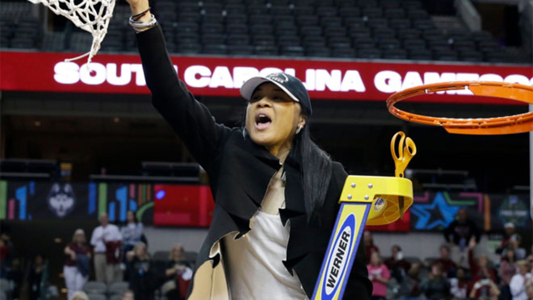 South Carolina coach Dawn Staley cuts down the net as she and the team celebrate their win over Mississippi State in the final of NCAA women's Final Four college basketball tournament