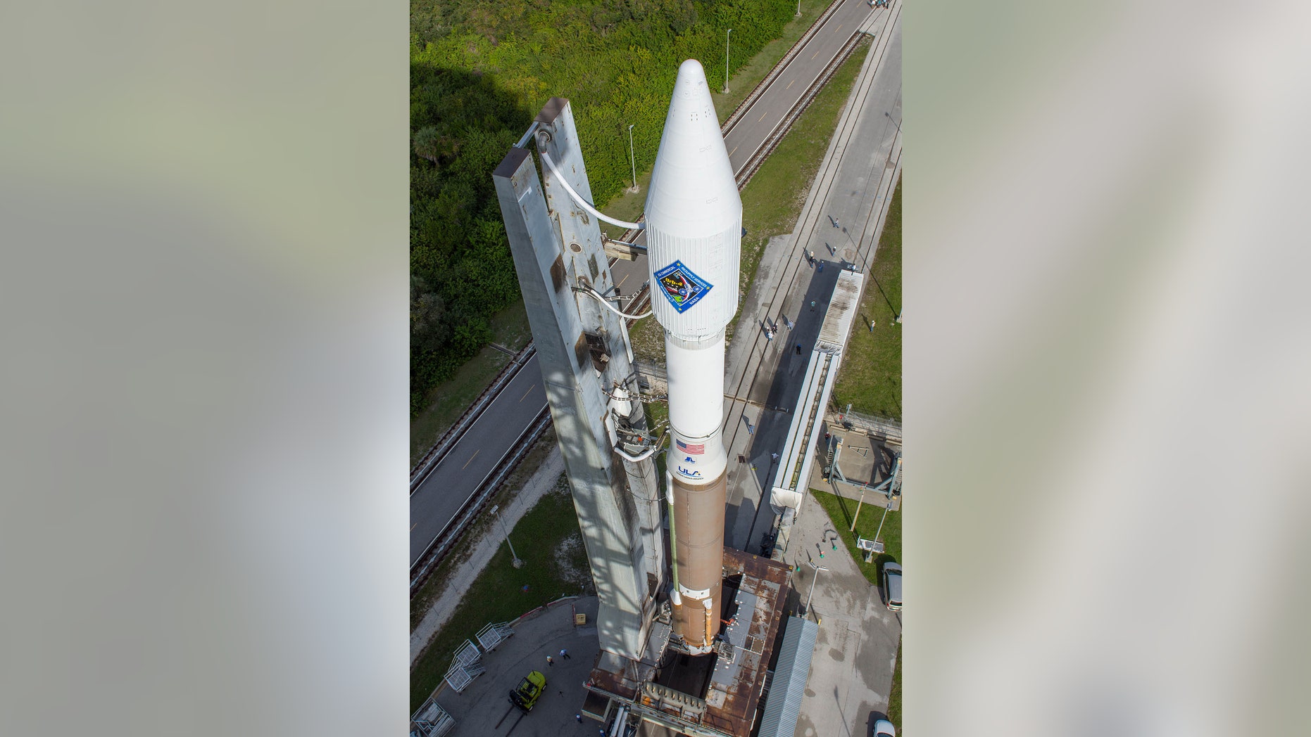 In this photo provided by the United Launch Alliance, an Atlas V rocket carrying the Orbital ATK Cygnus spacecraft, is rolled from the Vertical Integration Facility to a launch pad at the Cape Canaveral Air Force Station in Cape Canaveral, Fla., on Wednesday, Dec. 2, 2015. (United Launch Alliance via AP)