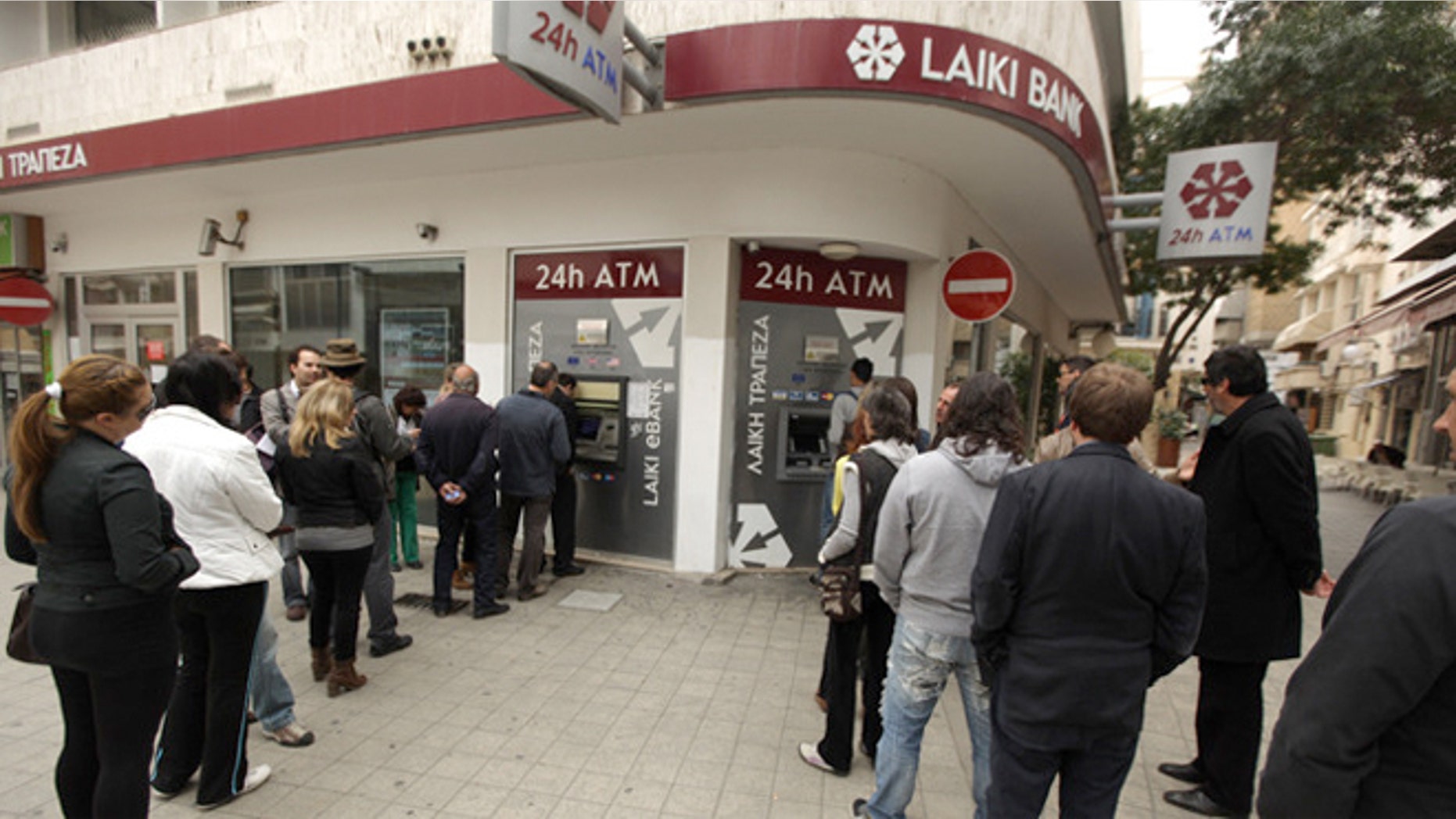 People in Cyrpus wait in line to withdraw money from an ATM of a Laiki Bank in the old city of the capital, Nicosia.