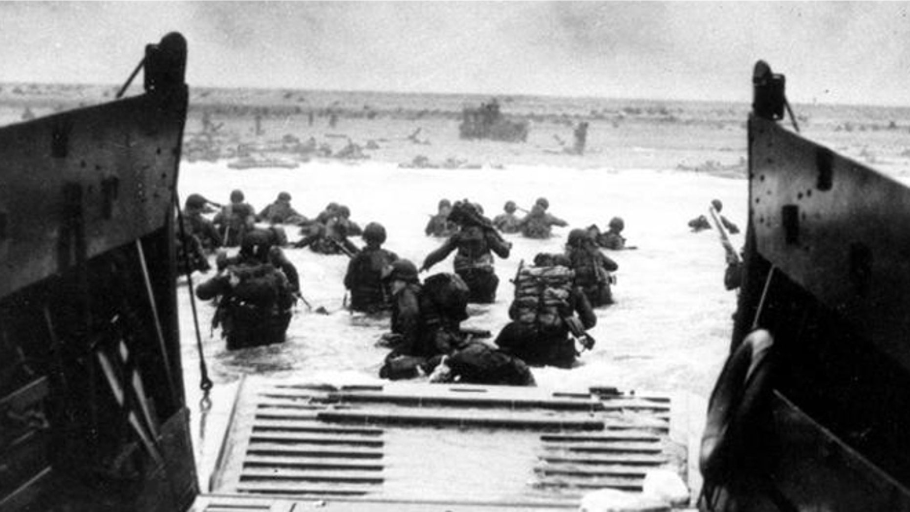 American troops wade ashore during Normandy invasion on D-Day.